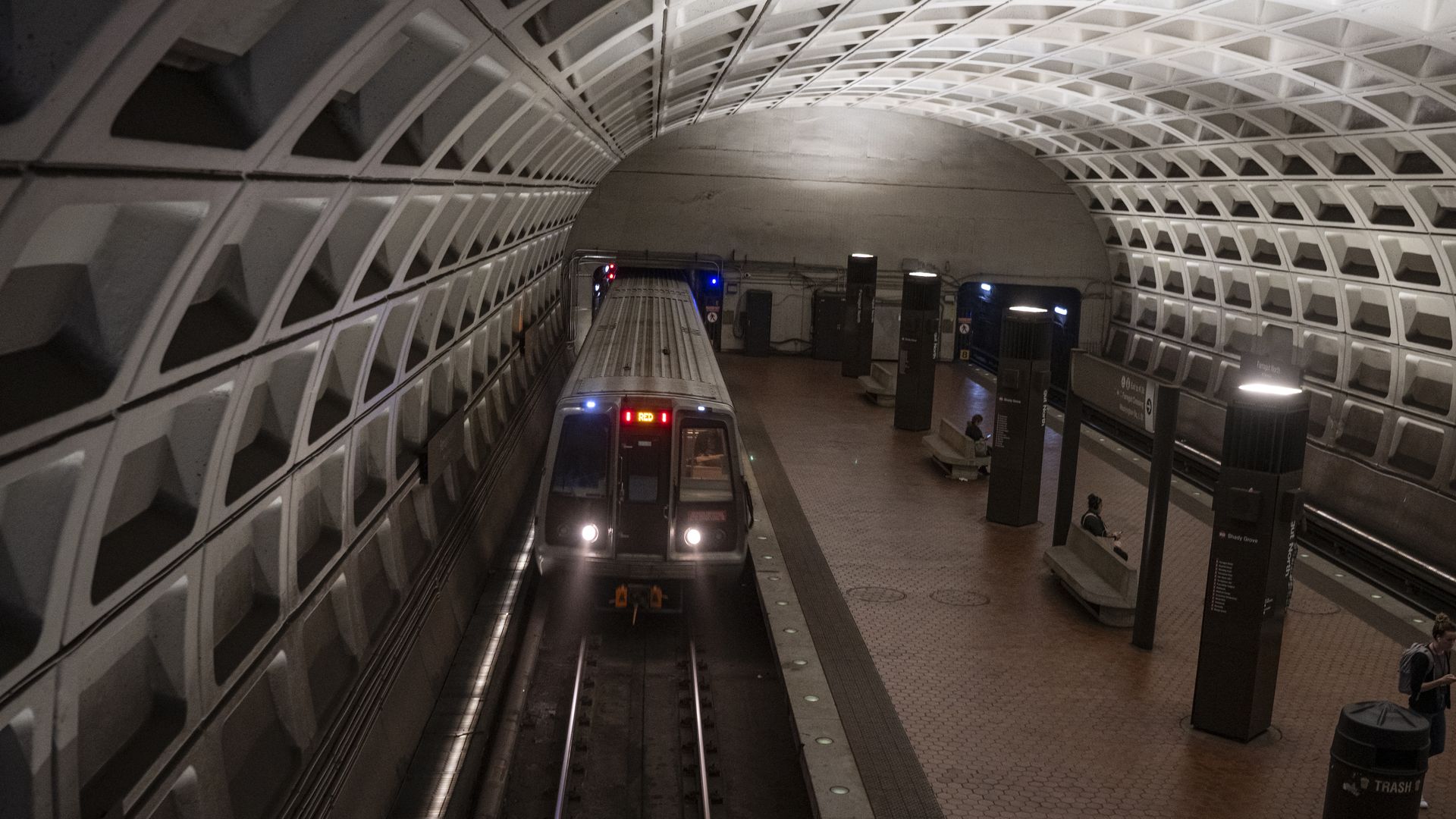 A photo of a Metro station with a train arriving.