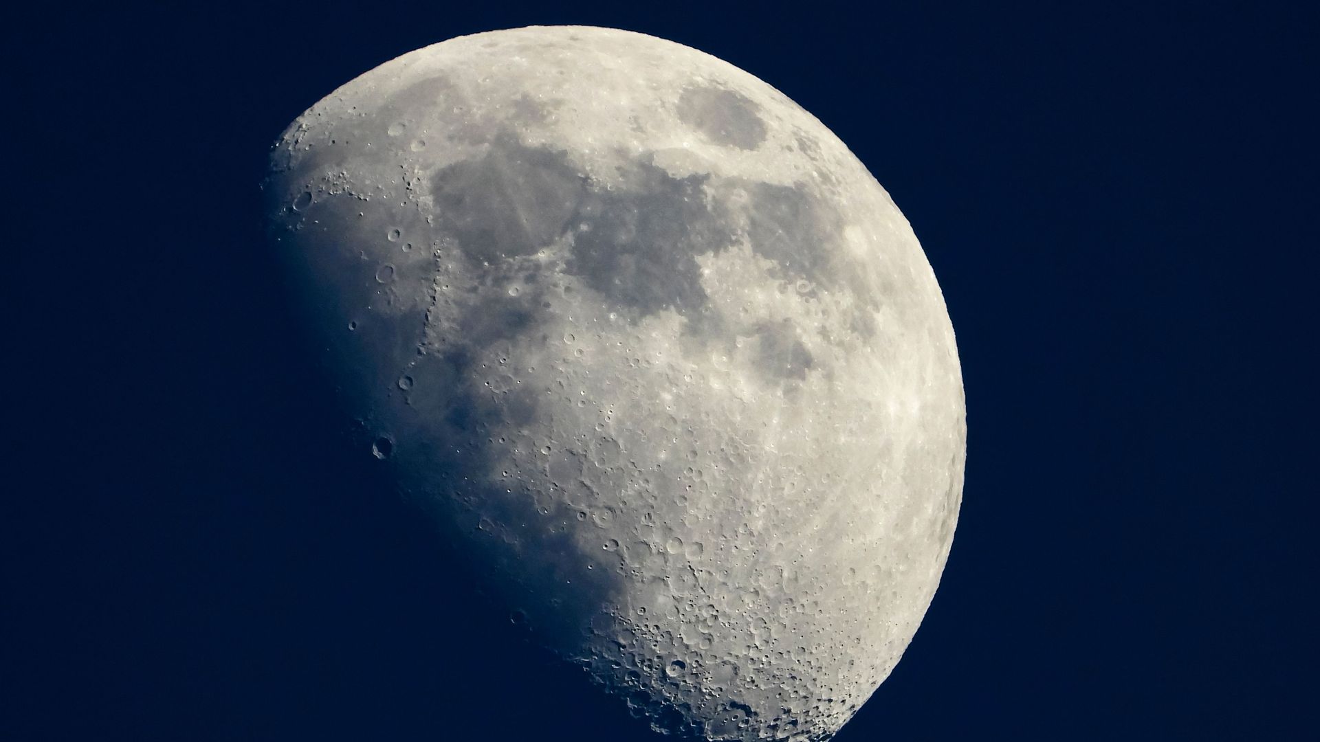 In this image, the moon is shown in a quarter full phase.