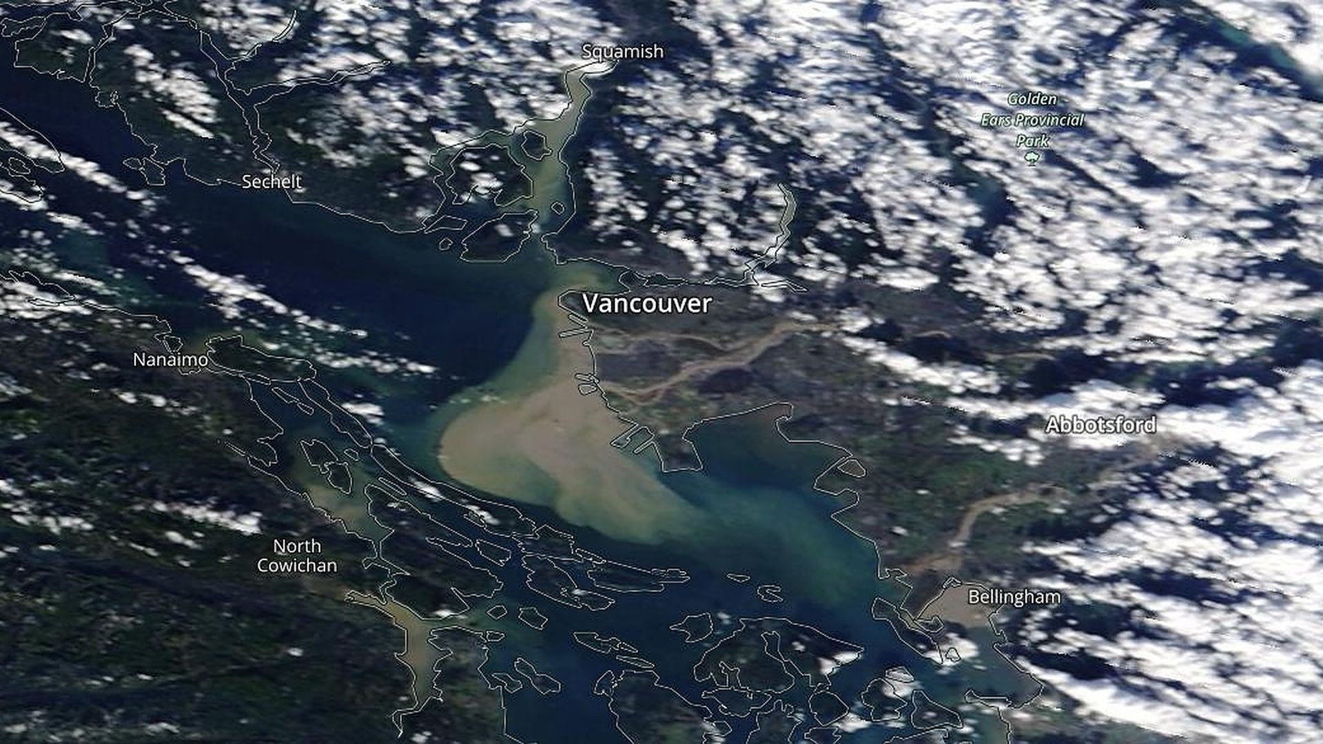 Runoff (dark brown) pours into the waters surrounding Vancouver, B.C. and Bellingham, Washington, causing flooding, as seen from space.