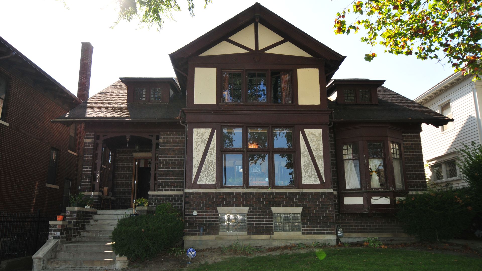 The exterior of the home with large open windows. 
