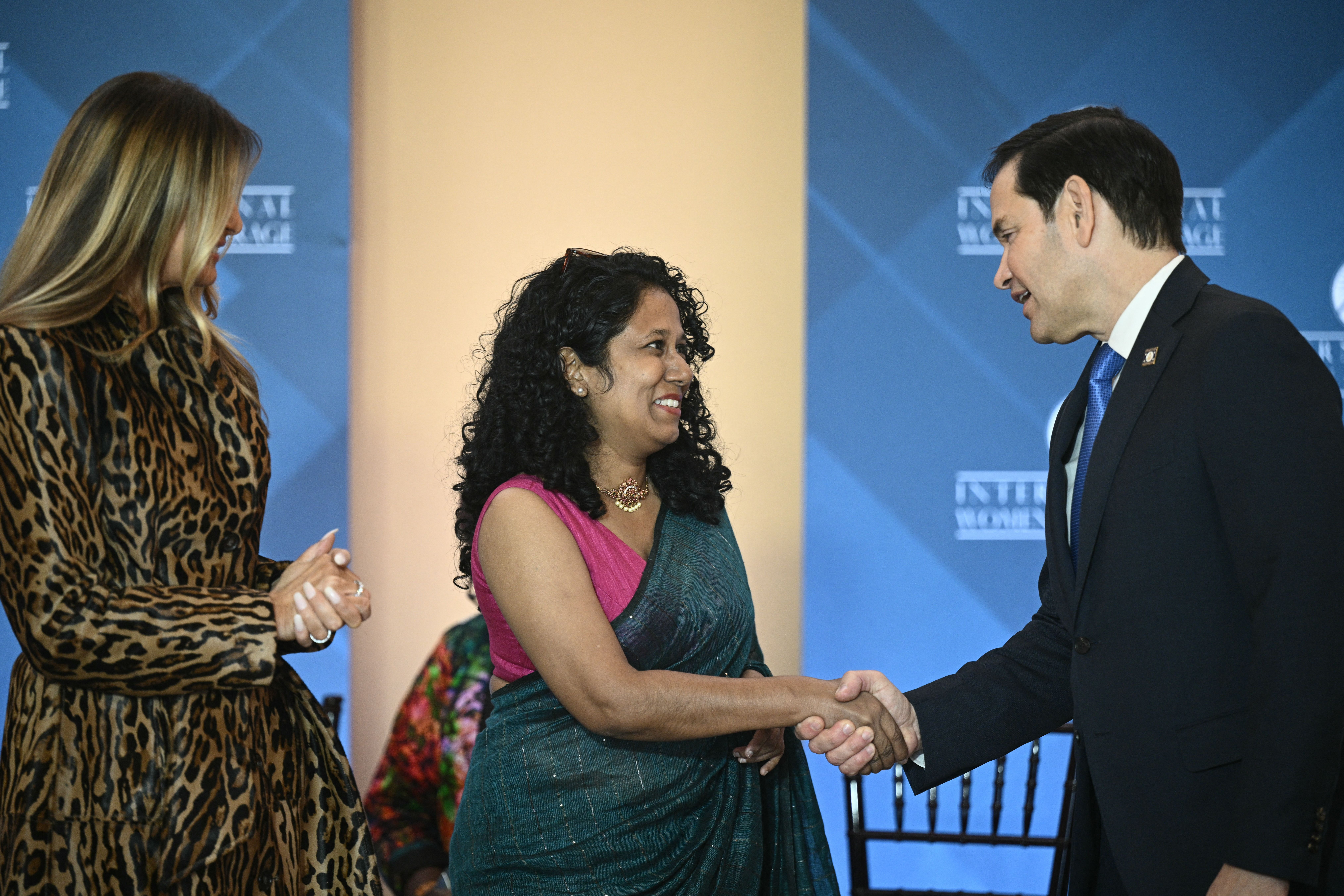 Namini Wijedasa (C), journalist from Sri Lanka, is congratulated by US Secretary of State Marco Rubio (R) and First Lady Melania Trump (L) during the International Women of Courage Awards Ceremony at the State Department in Washington, DC, on April 1, 2025. 