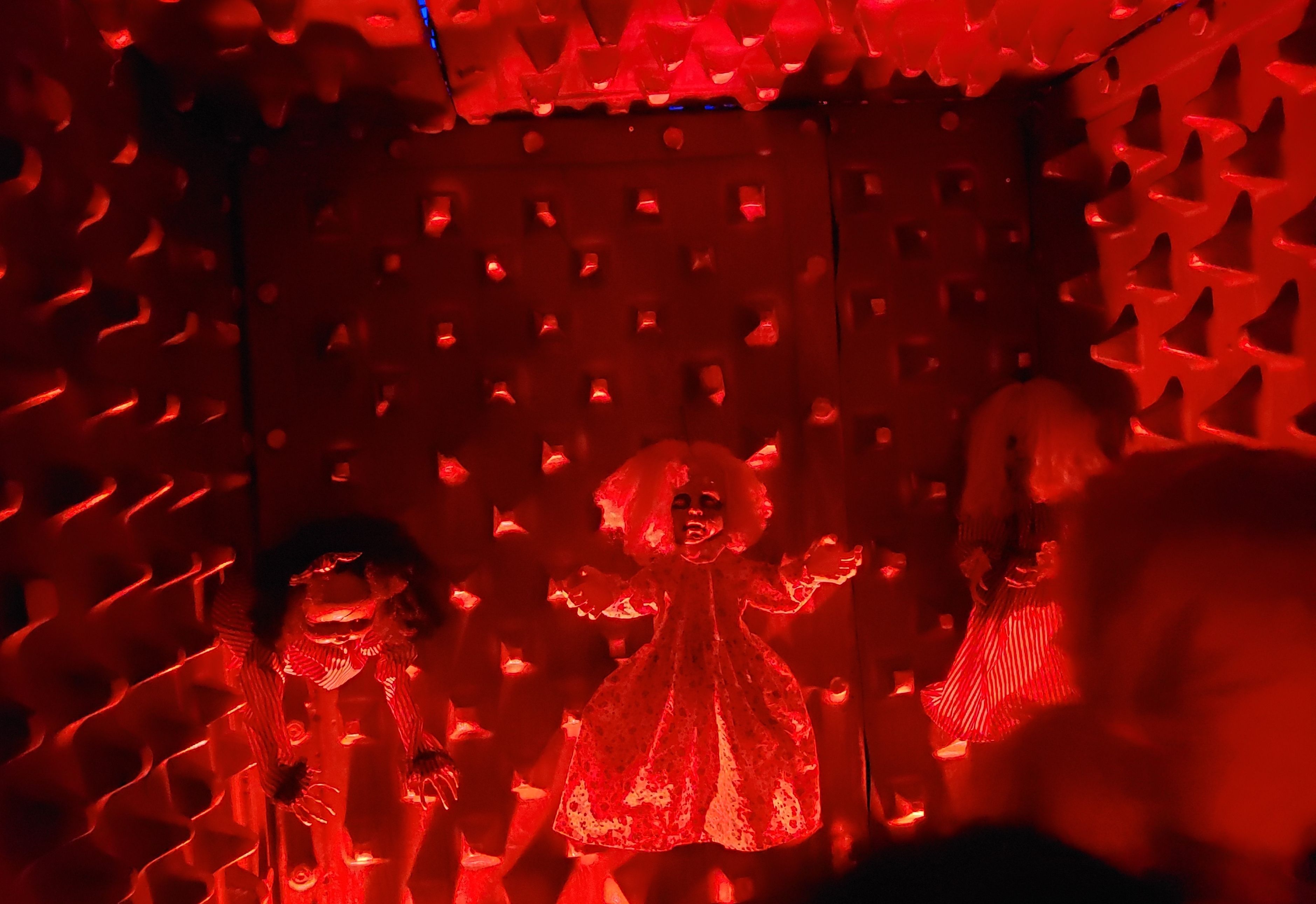 Black and red room with doll in center