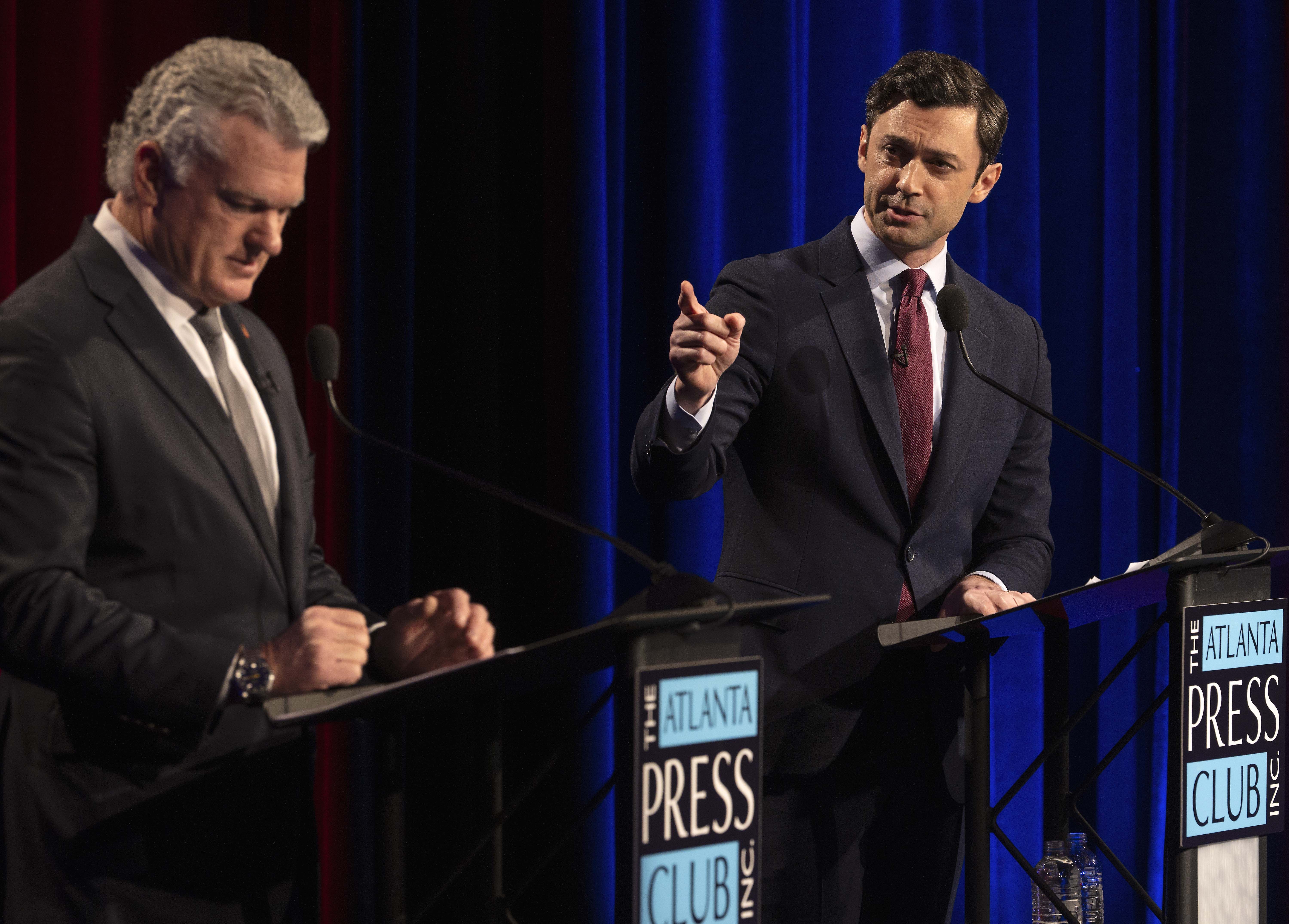 Sen. Jon Ossoff (D-Ga.) and Rep. Mike Collins (R-Ga.), the Republican Senate challenger, debate in Atlanta last night.
