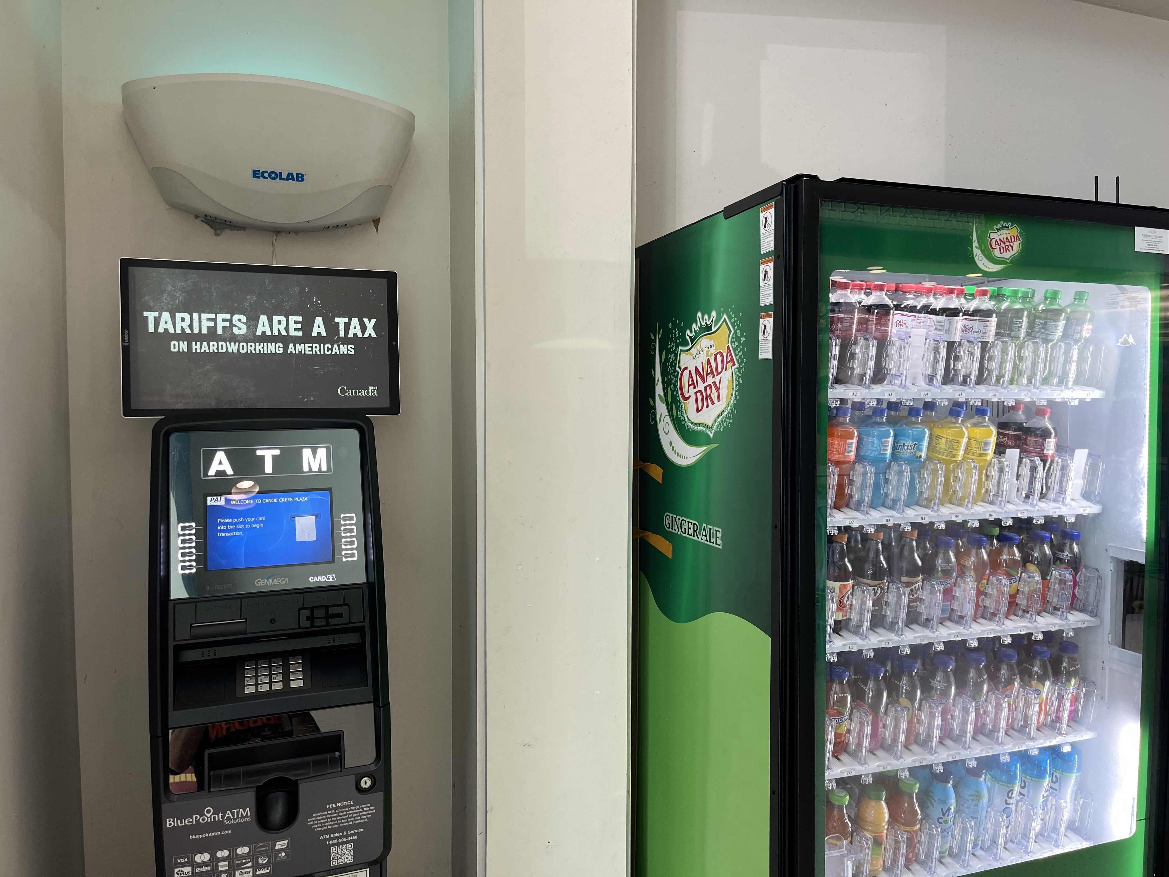 A vending machine and an ATM with the phrase 'Tariffs are a tax on hardworking Americans.'