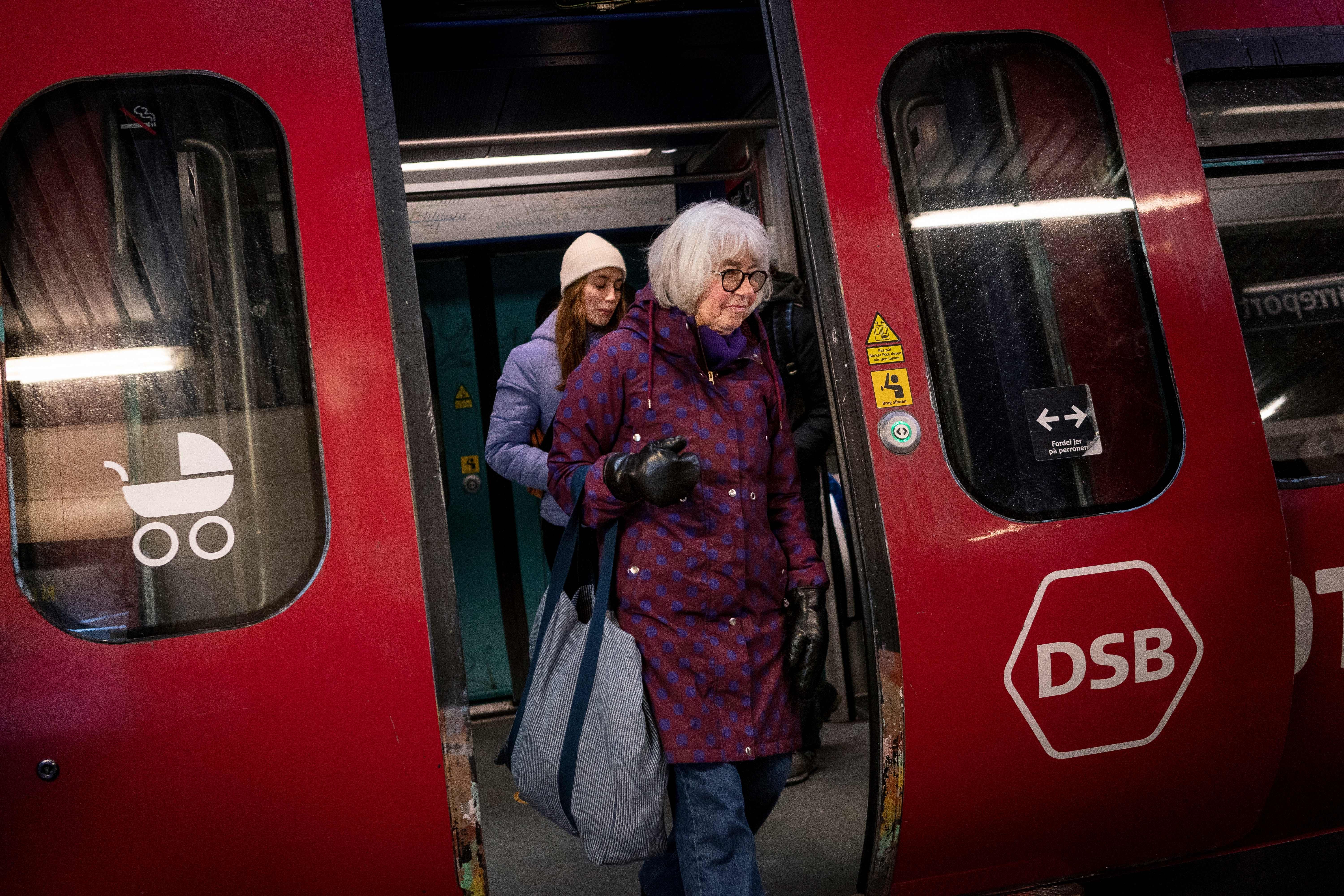 People walking through Nørreport metro station in Copenhagen after Denmark lifted most coronavirus restrictions.