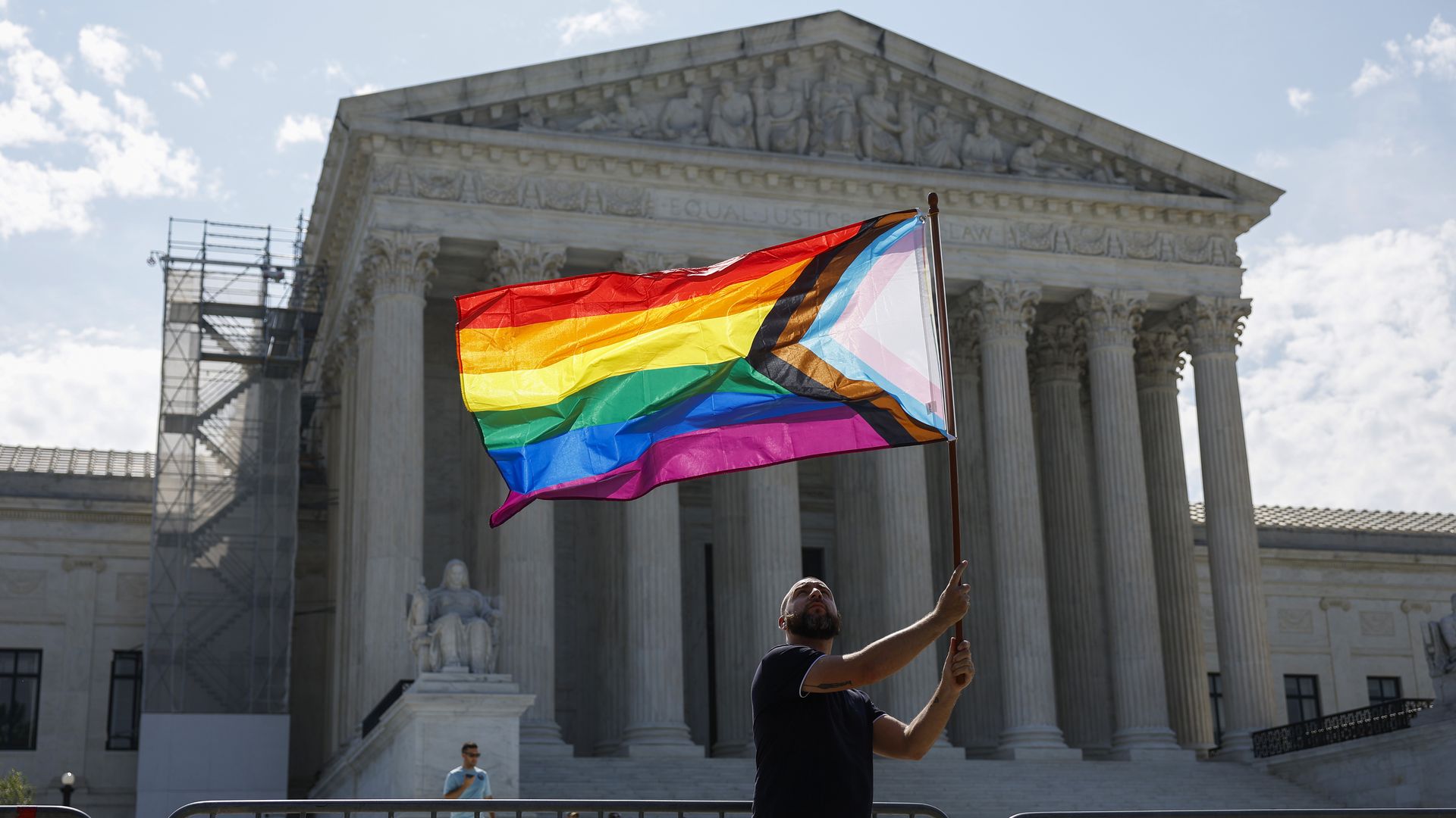 Vin Testa waves a LGBTQ+ pride flag in front of the U.S. Supreme Court Building as he makes pictures with his friend Donte Gonzalez to celebrate the anniversary of the United States v. Windsor and the Obergefell v. Hodges decisions on June 26, 2023. Photo: Anna Moneymaker/Getty Images
