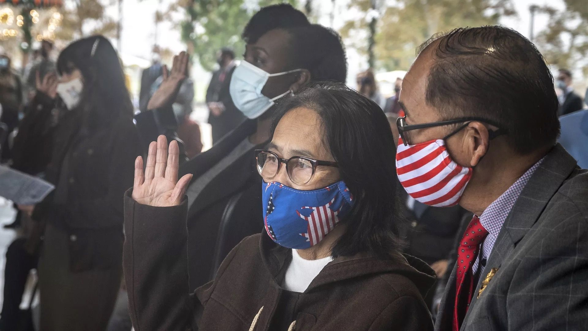 A woman is seen being sworn in during a U.S. naturalization ceremony.