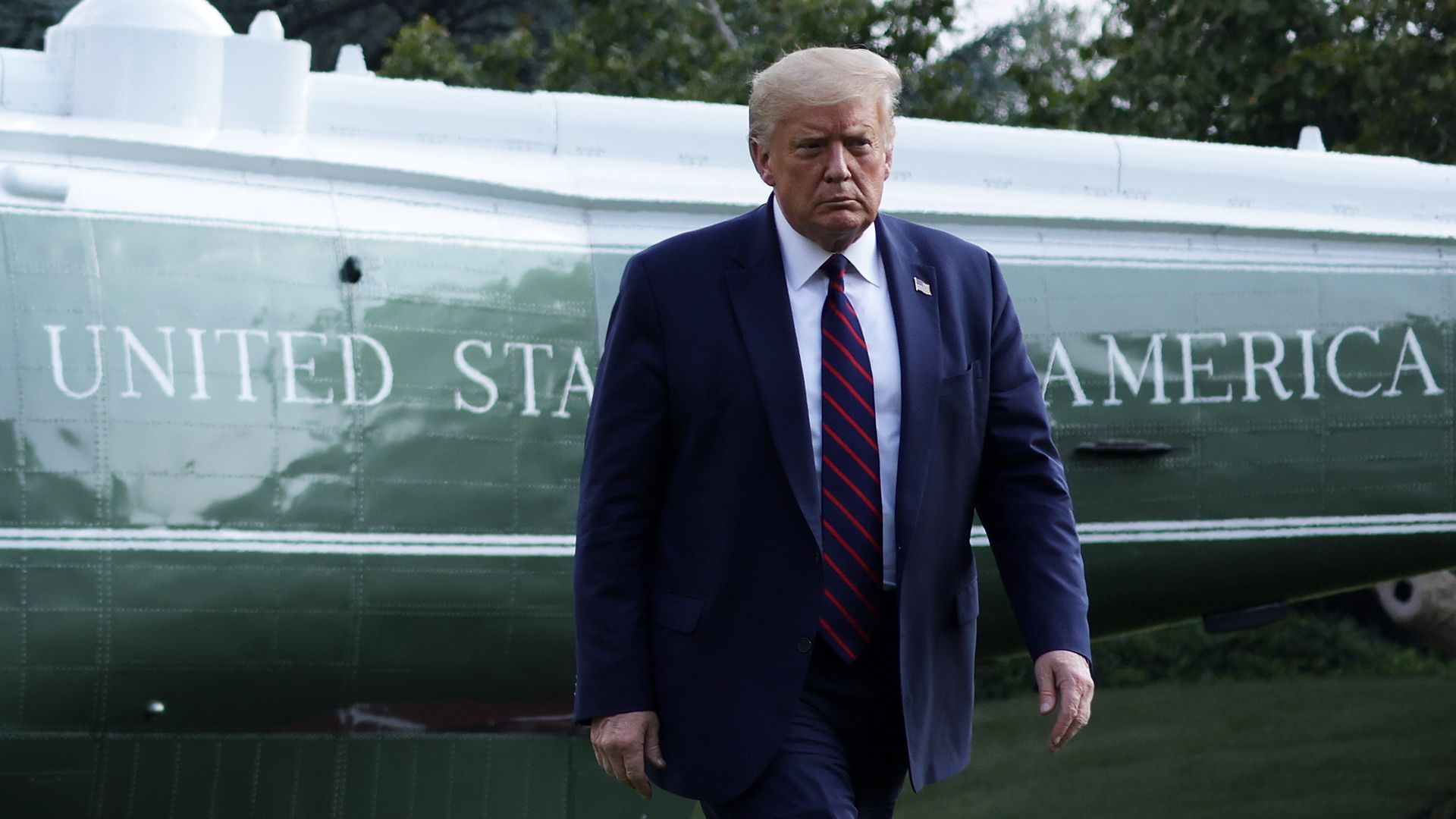 Donald Trump walking away from Marine One at the White House