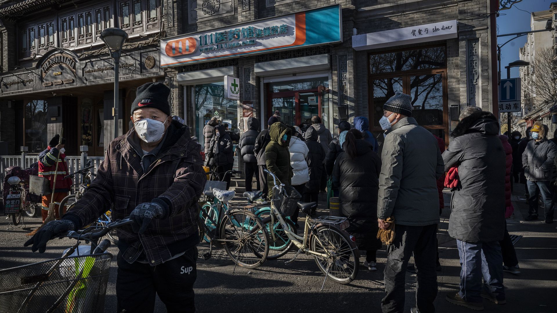 BEIJING, CHINA - DECEMBER 11: People gather outside a local pharmacy to buy medications to treat COVID-19 symptoms in the morning on December 11, 2022 in Beijing, China