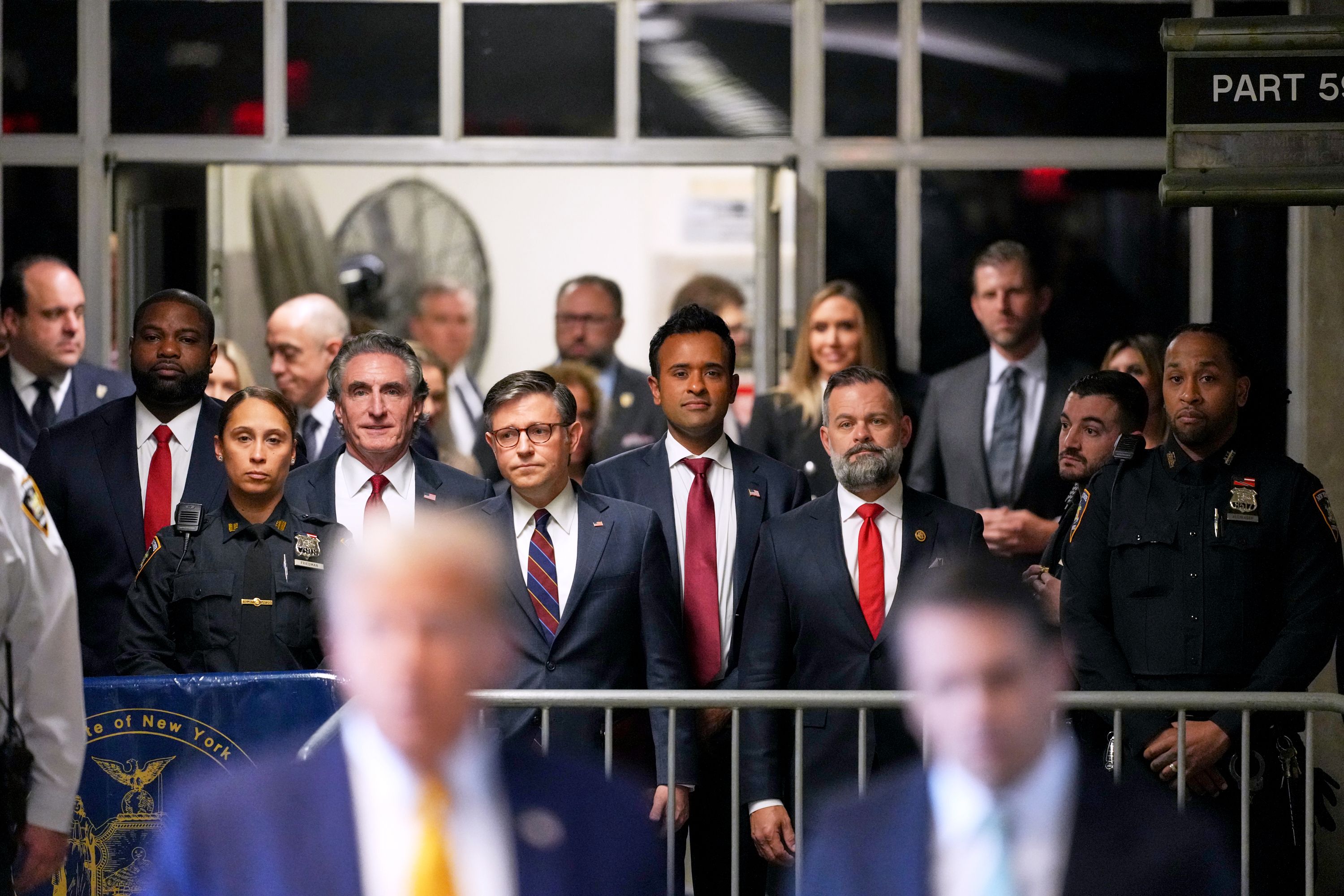 Representative Byron Donalds, a Republican from Florida, from left, Doug Burgum, governor of North Dakota, US House Speaker Mike Johnson, a Republican from Louisiana, Vivek Ramaswamy, chairman and co-founder of Strive Asset Management, and Representative Cory Mills, a Republican from Florida, watch as former US President Donald Trump, center left, and Todd Blanche, attorney for former US President Donald Trump, center right, speak to members of the media while arriving at Manhattan criminal court in New York, US, on Tuesday, May 14, 2024
