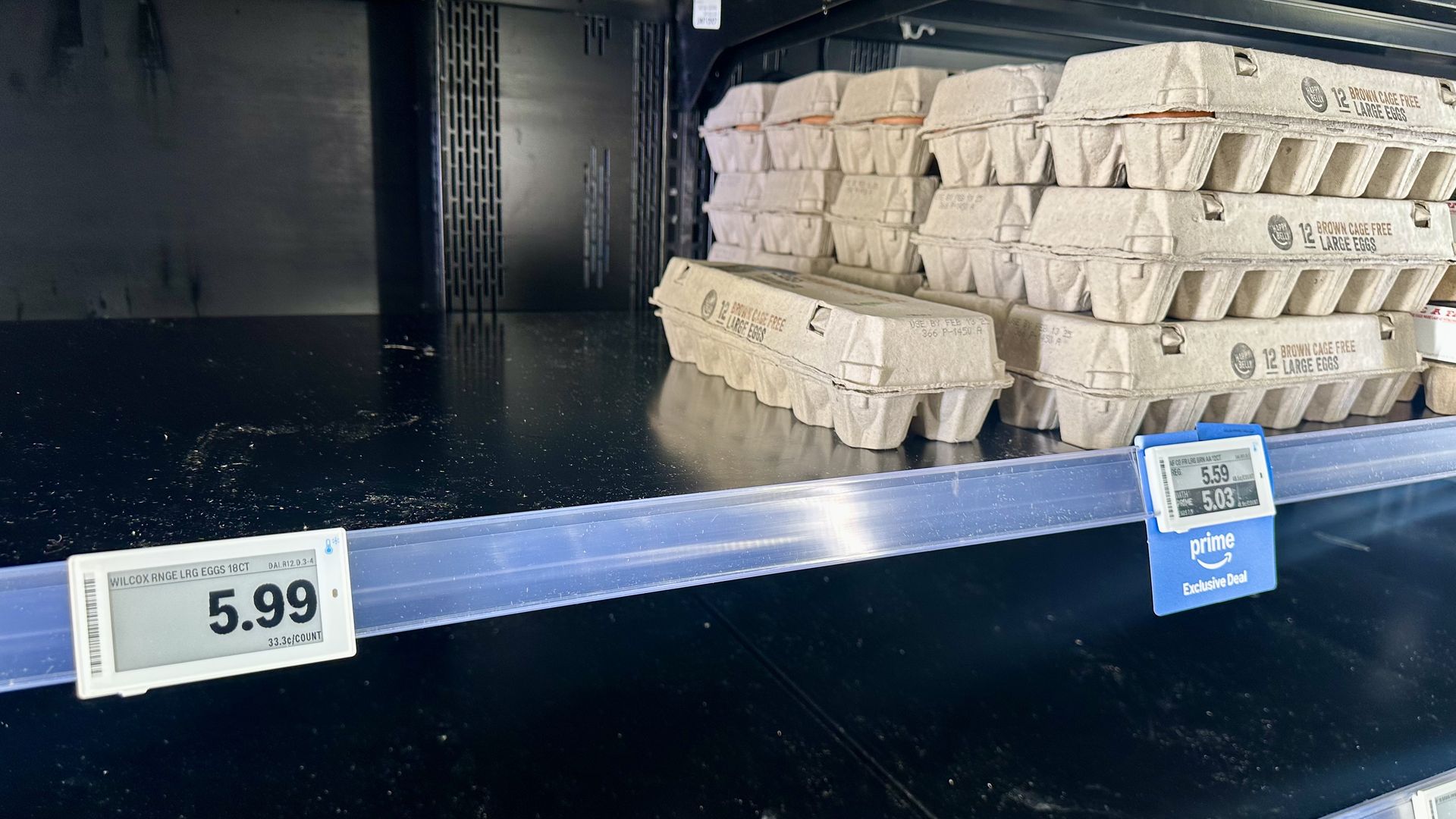 Partially empty egg shells with price tags for dozen eggs above $5.