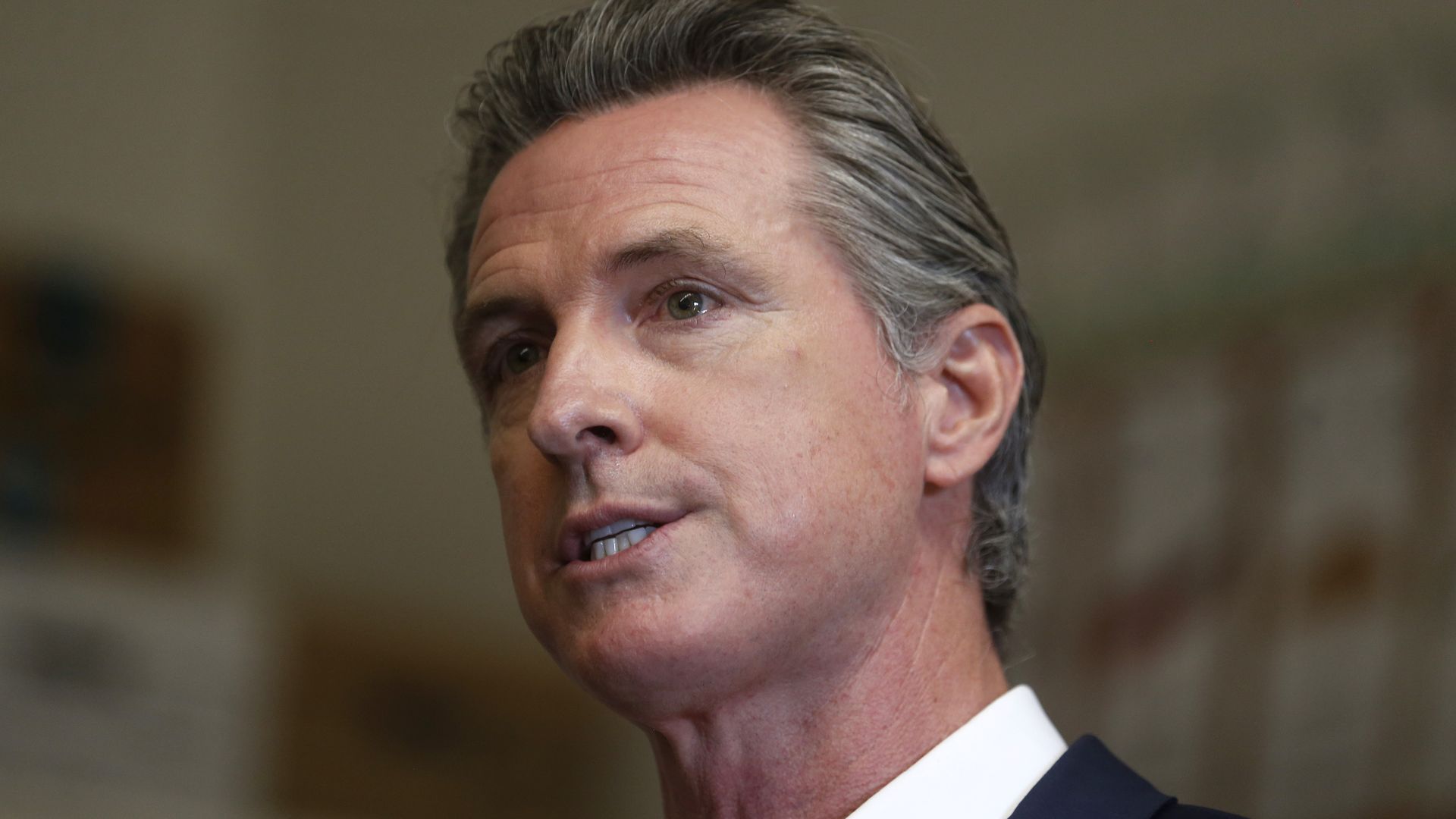 Gov. Gavin Newsom speaks to the press while visiting Melrose Leadership Academy in Oakland, Calif.