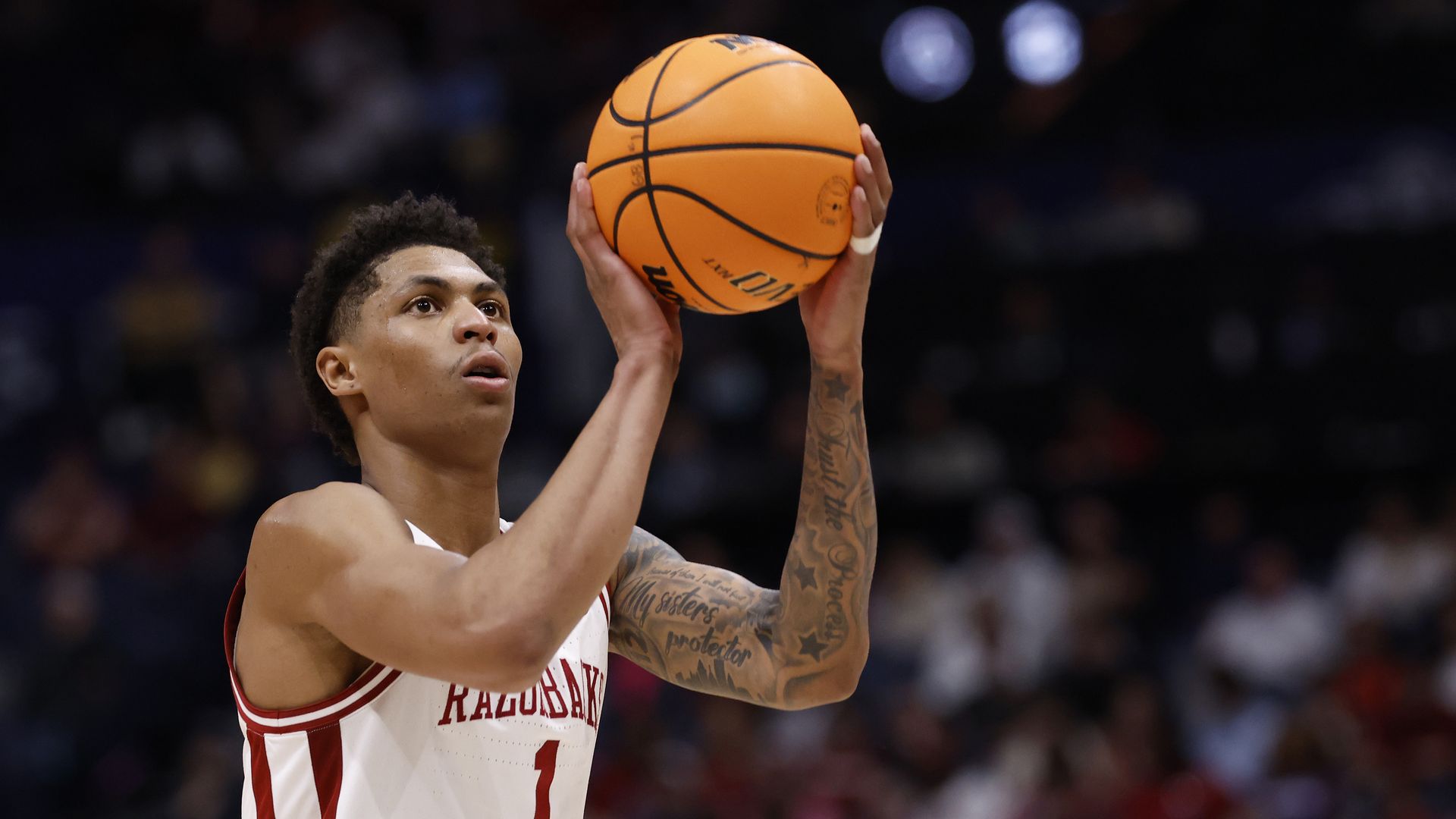 Player in white jersey No.1 shoots orange basketball
