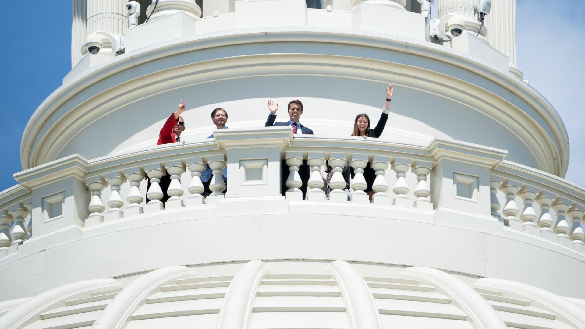 Tourists are seen waving from atop the Capitol Dome.