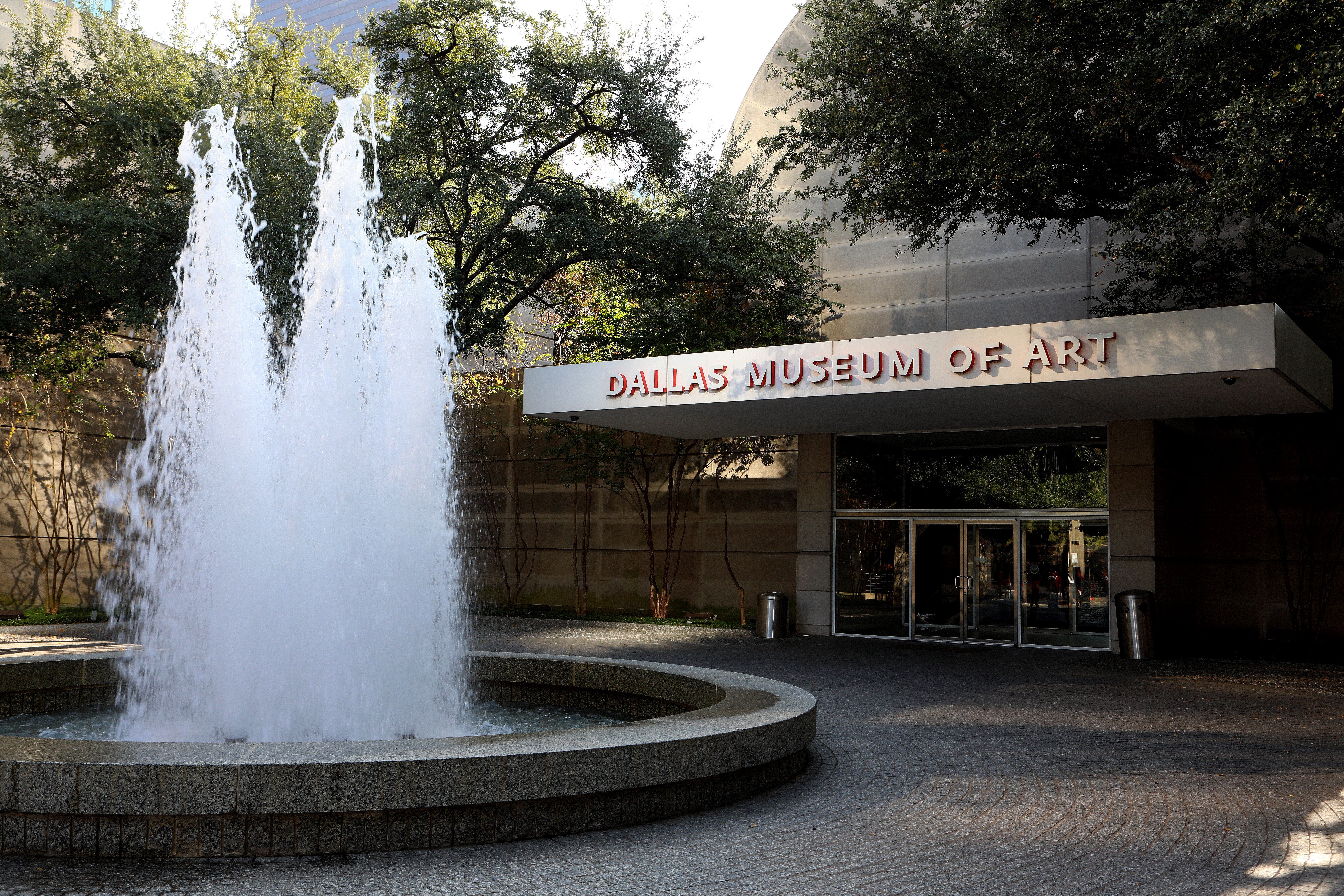 Fountain shooting water in front of sign that says "Dallas Museum of Art"