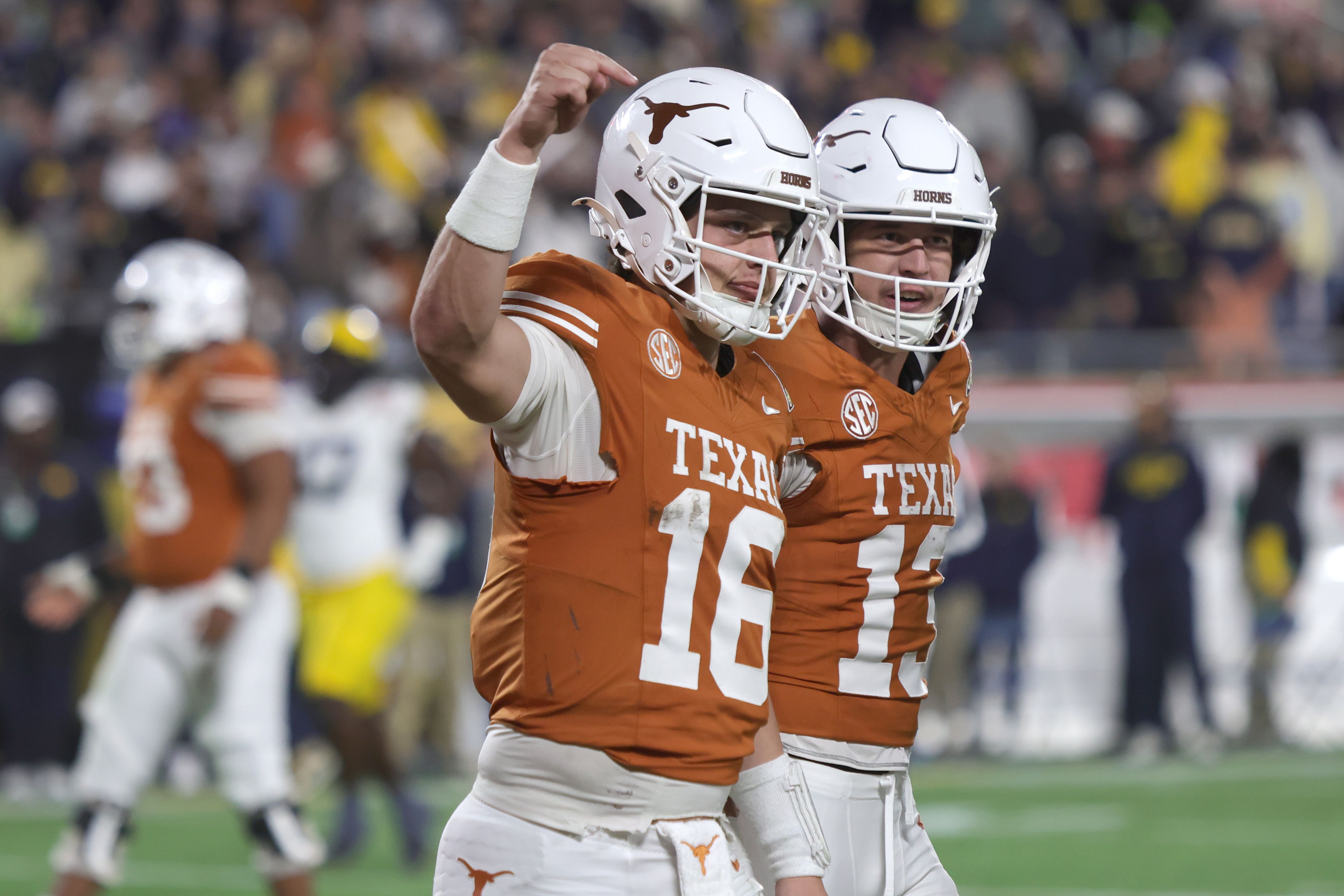 Arch Manning #16 of the Texas Longhorns celebrates his 60-yard touchdown in the 4th quarter of the 2025 Cheez-It Citrus Bowl between the Texas Longhorns and Michigan Wolverines at Camping World Stadium on December 31, 2025 in Orlando, Florida. (Photo by Dustin Markland/Getty Images)