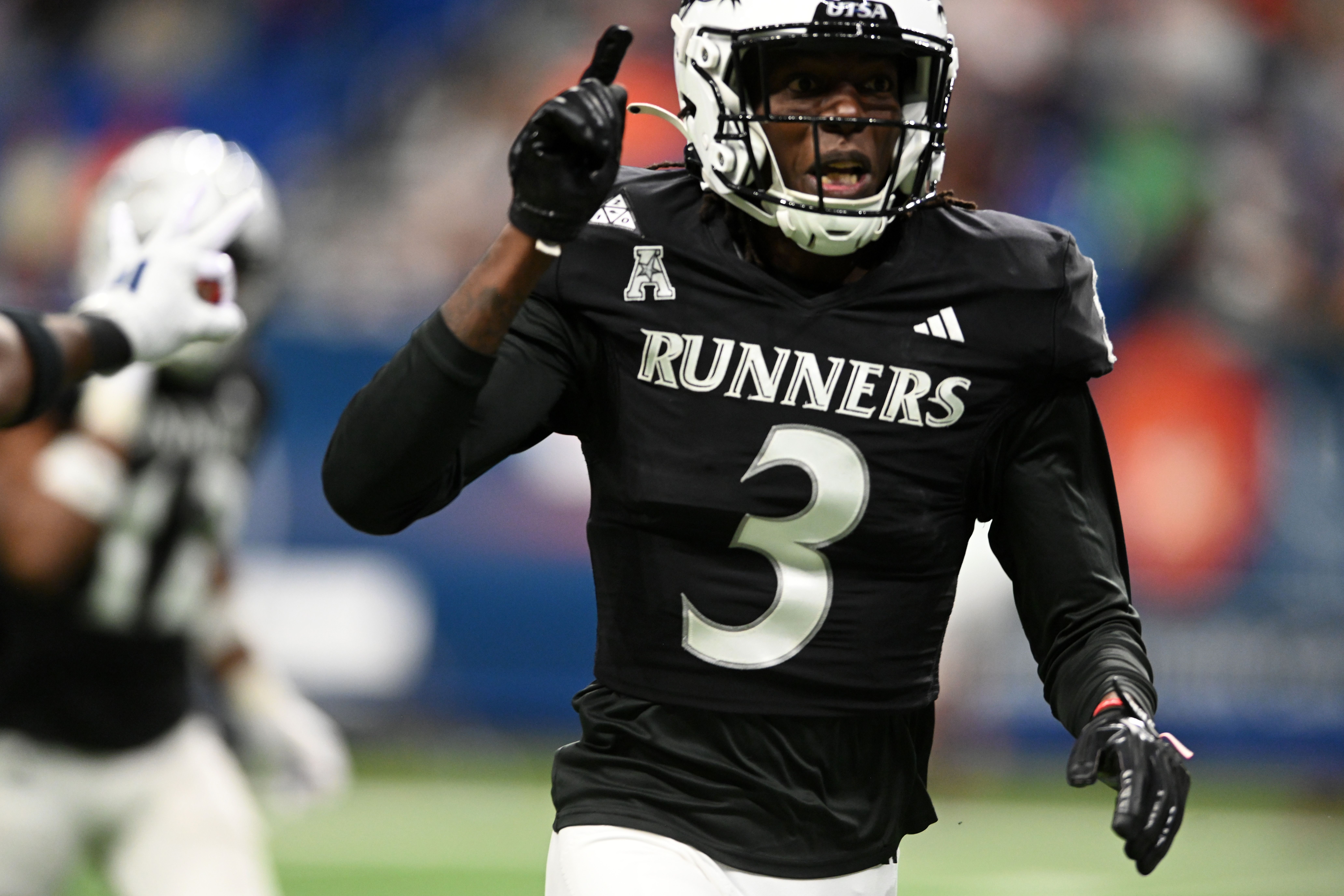 Photo of a football player celebrating on a football field. 