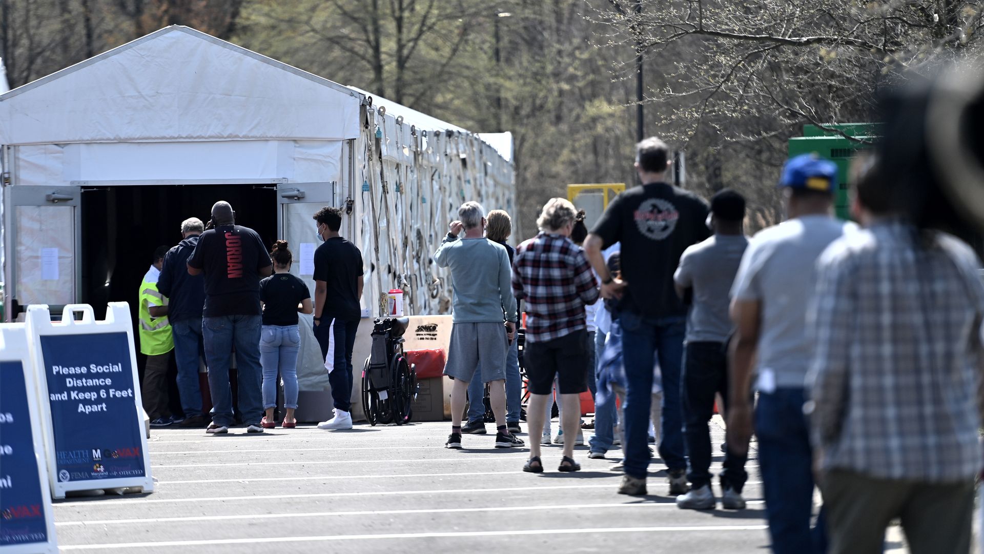 People waiting in line at a mass vaccination site