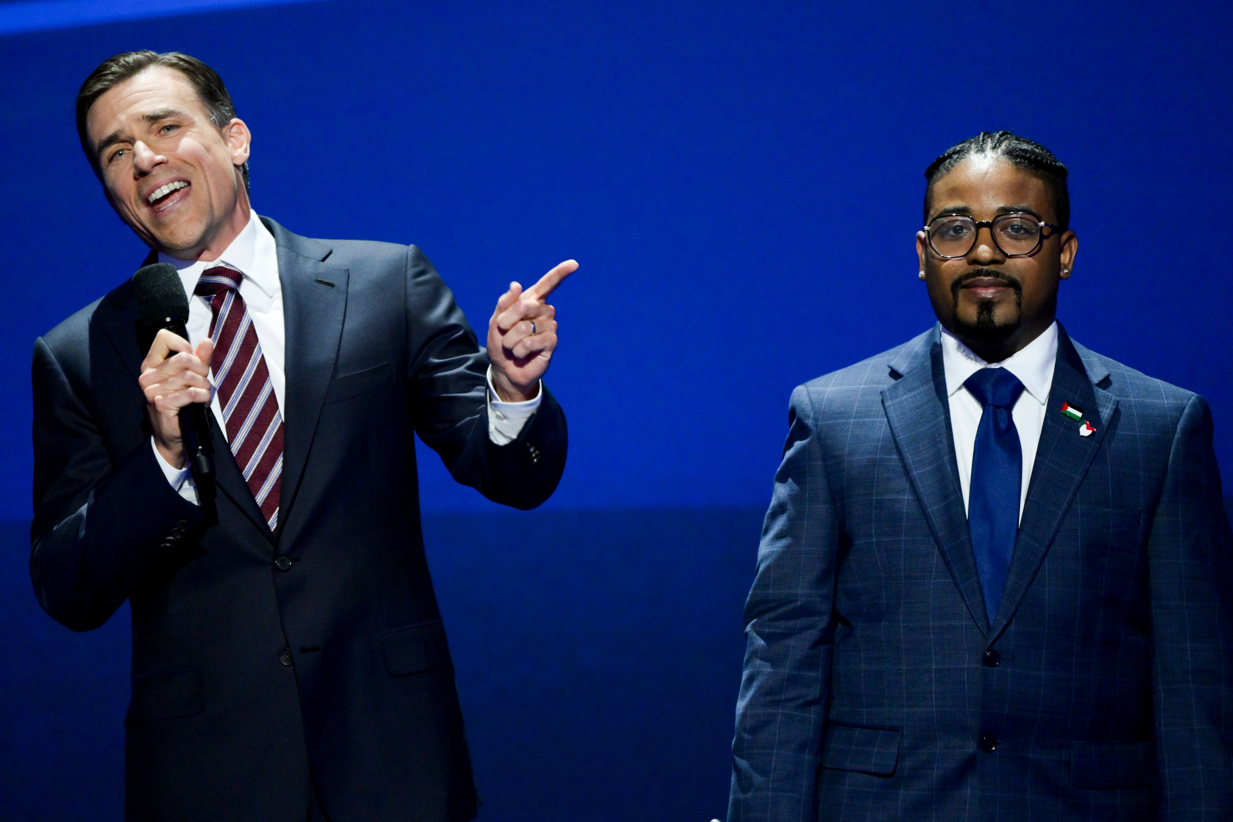 Tristan Snell, former assistant attorney general of New York, left, and Nathan Hornes, former student at Corinthian Colleges, during the Democratic National Convention (DNC) at the United Center in Chicago, Illinois, US, on Thursday, Aug. 22, 2024.