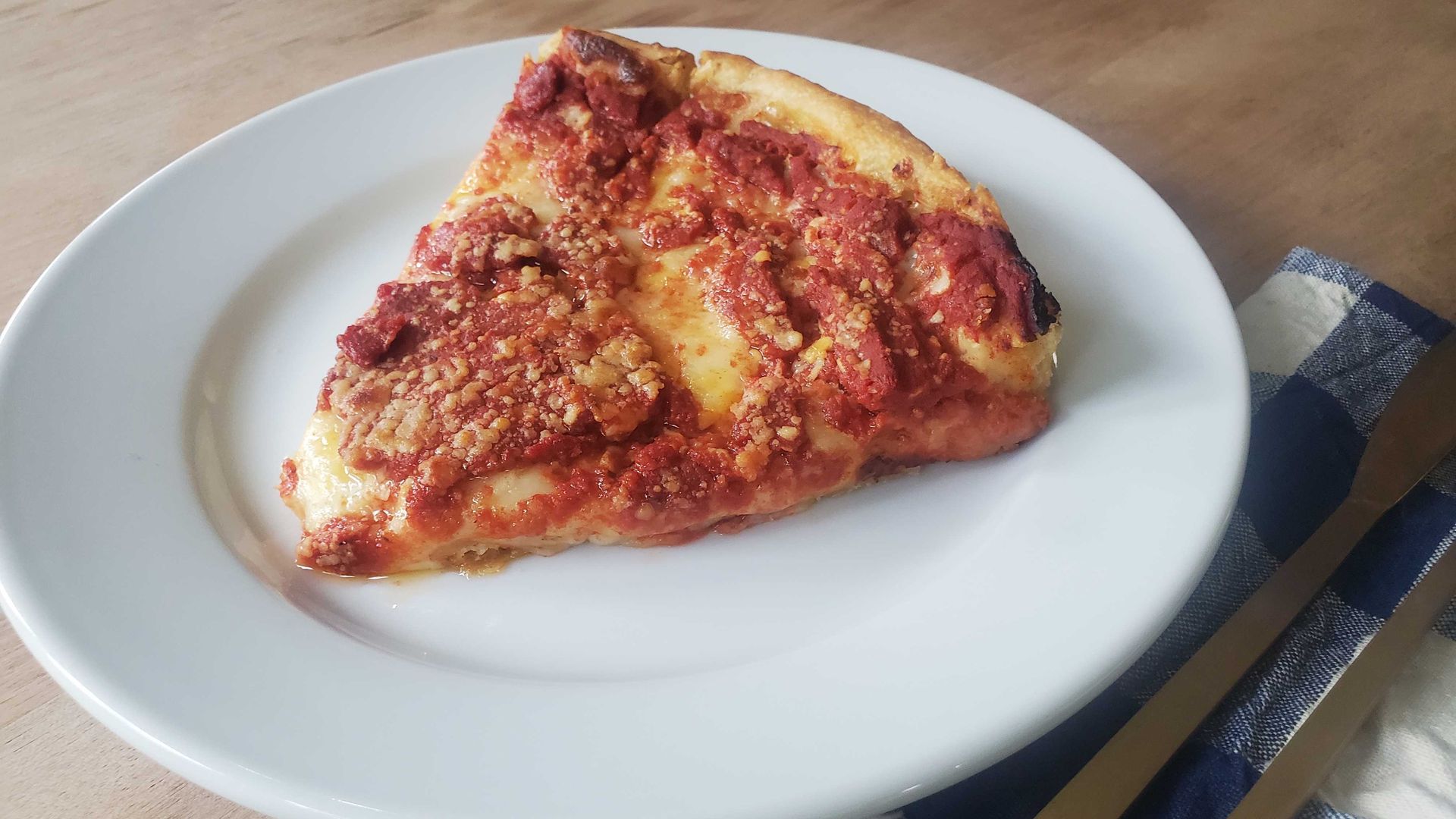 A piece of chicago-style deep dish pizza.