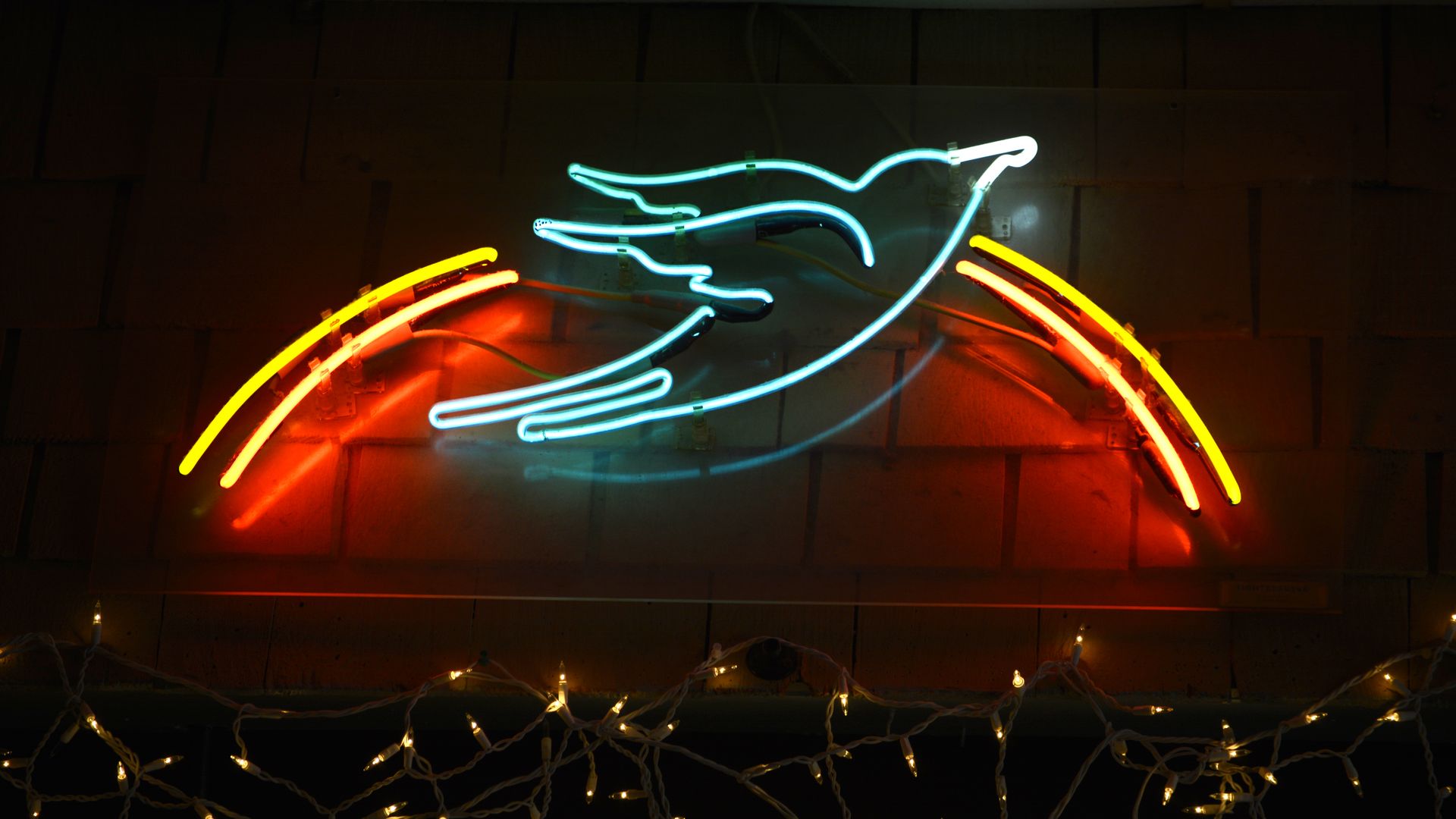 A neon sign in the shape of a bluebird burns above the stage at the iconic Bluebird Cafe in Nashville, Tennessee.