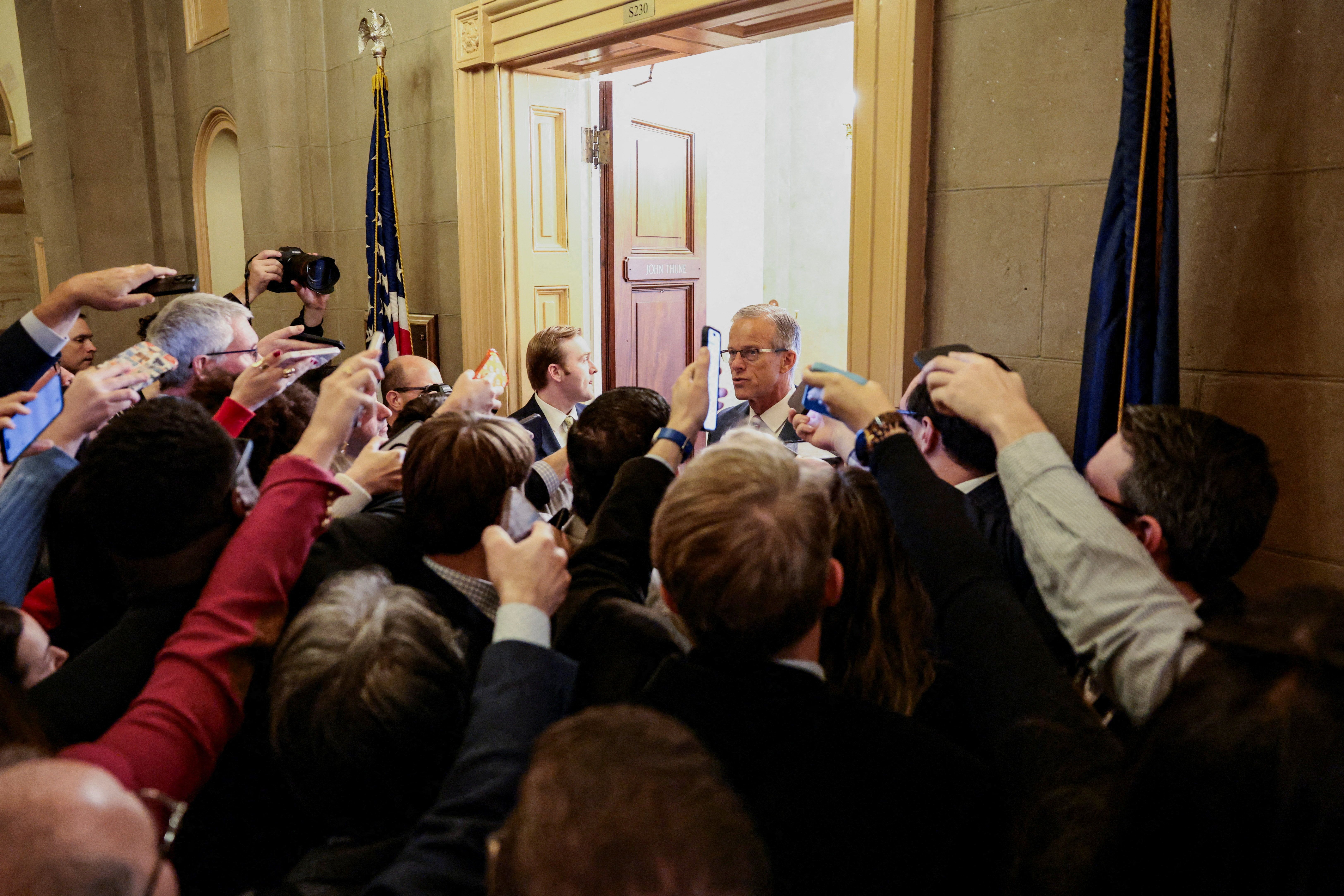 Senate Majority Leader John Thune speaks to reporters yesterday as he walks to the Senate floor. Photo: Evelyn Hockstein/Reuters