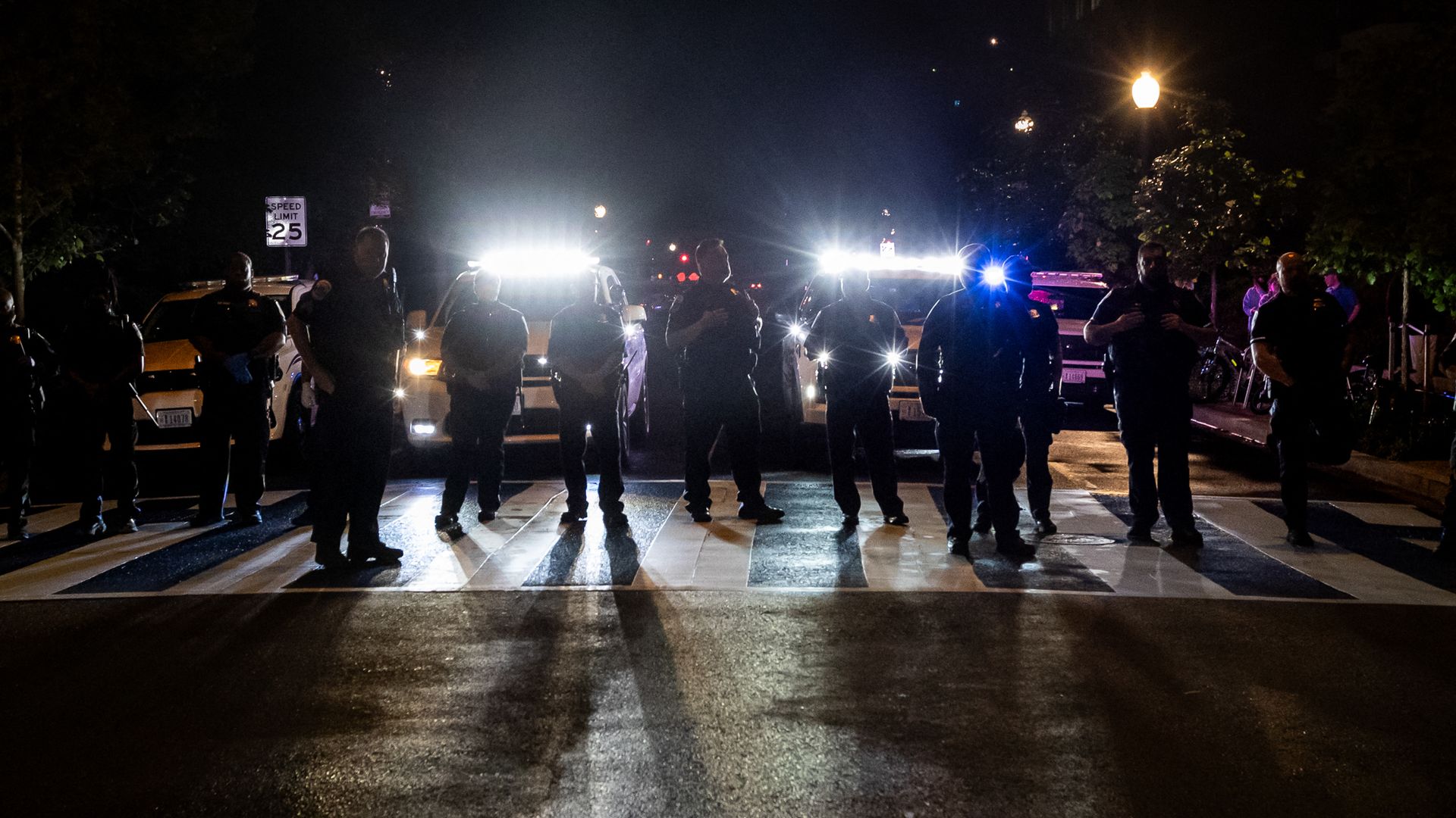Police stand on a crosswalk