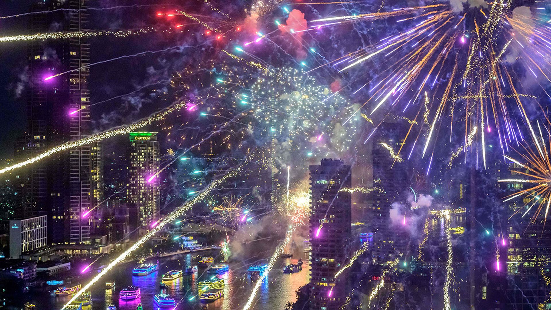 New Year's Eve fireworks erupt over the Chao Phraya river during the fireworks show in Bangkok on January 1, 2021.