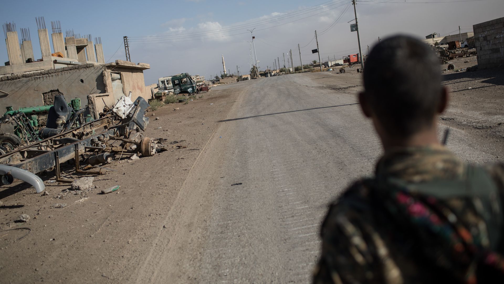 A fighter of the Syrian Democratic Forces (SDF) stands in an an empty street in the western neighborhood of Jazrah on the outskirts of Raqqa in October.