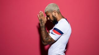 Team USA soccer player Deondre Yedlin clasps his hands in prayer during a World Cup photo shoot.