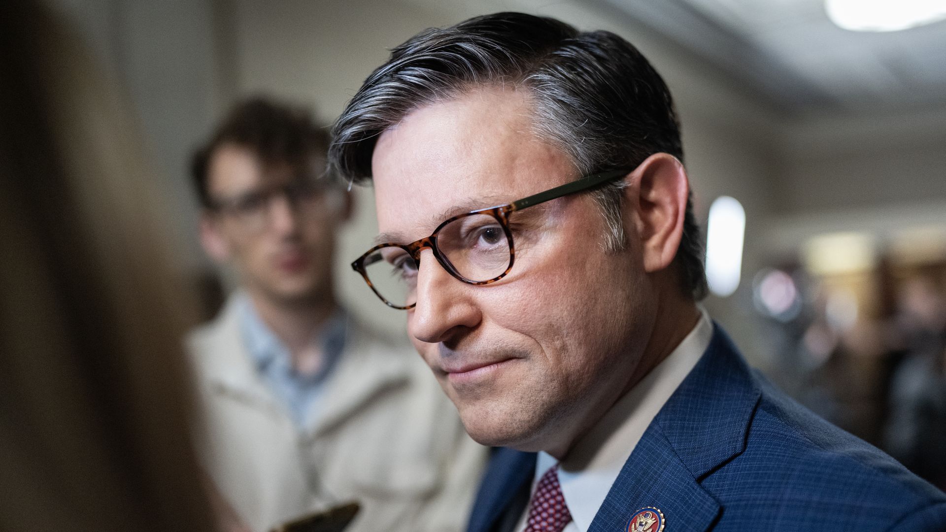 Mike Johnson stands outside a House Republican meeting
