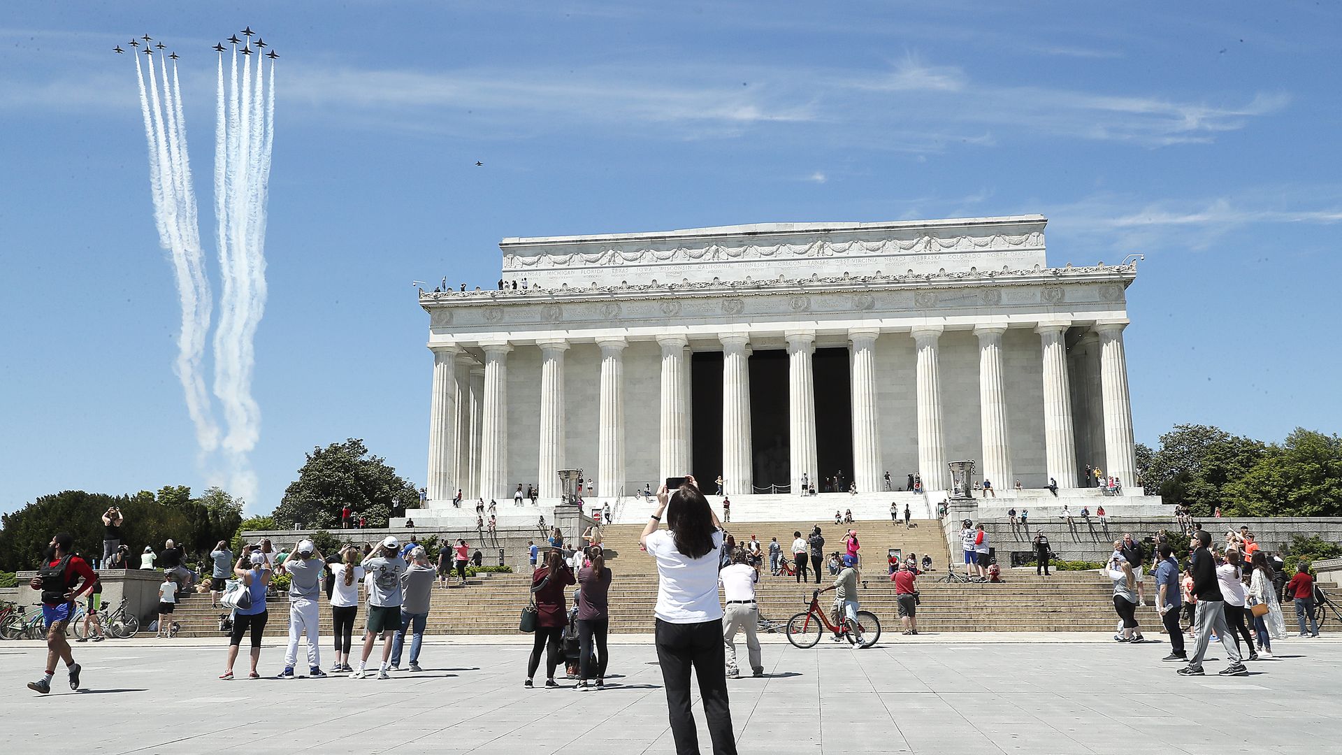 In this image, the blue angels fly past the Lincoln Monument 