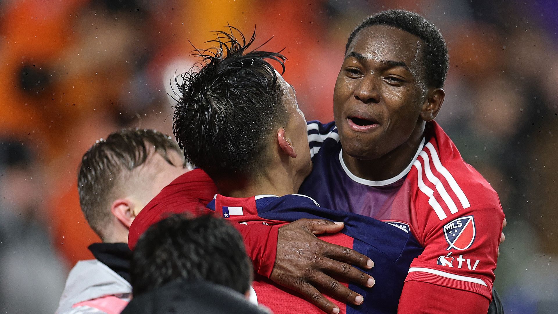 FC Dallas player Anderson Julio celebrates by hugging a teammate after scoring a goal 
