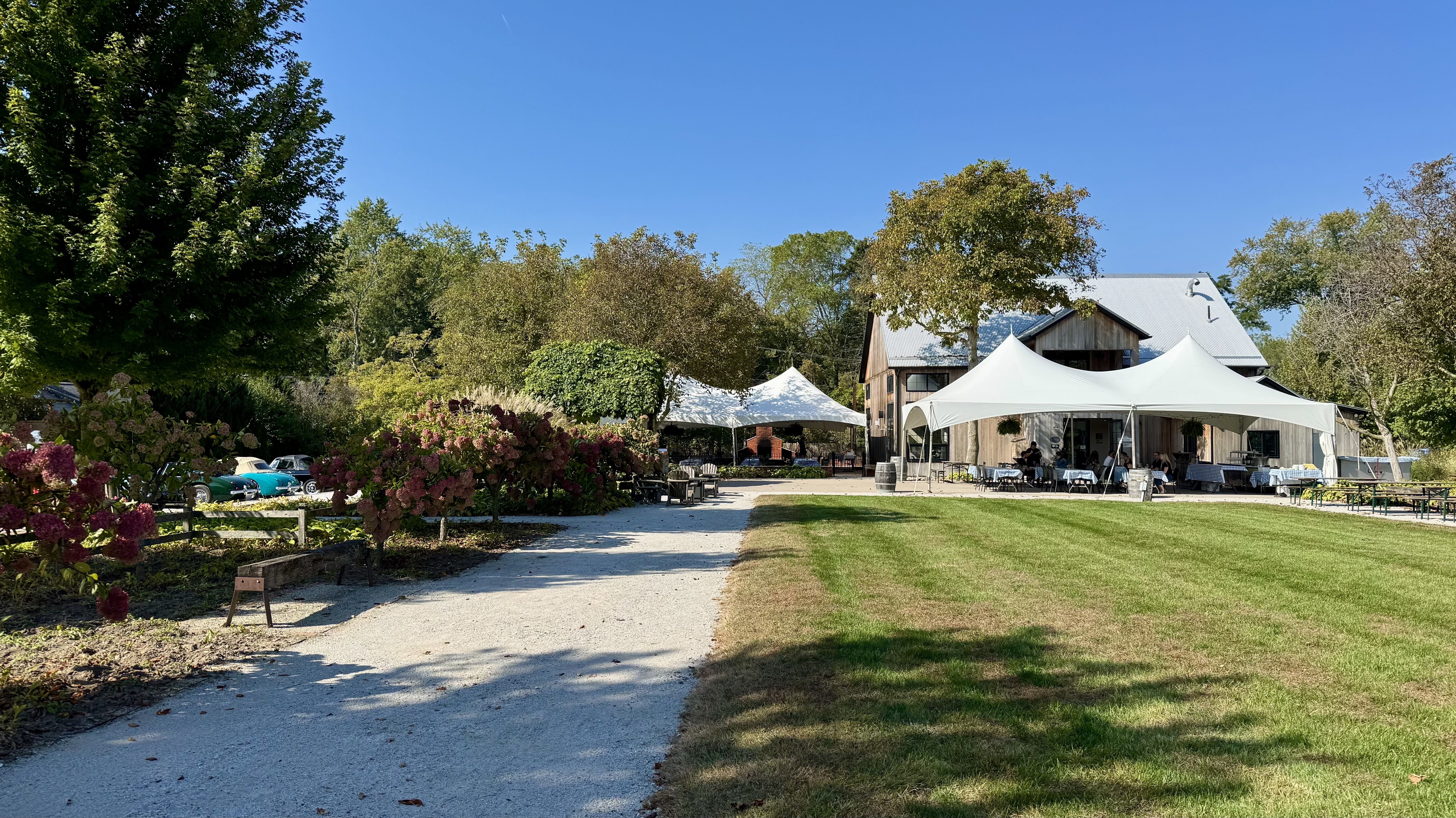 A view of the green grounds and a wooden building