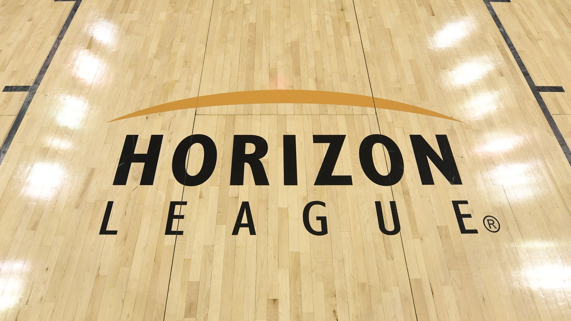 The Horizon League logo on a basketball court