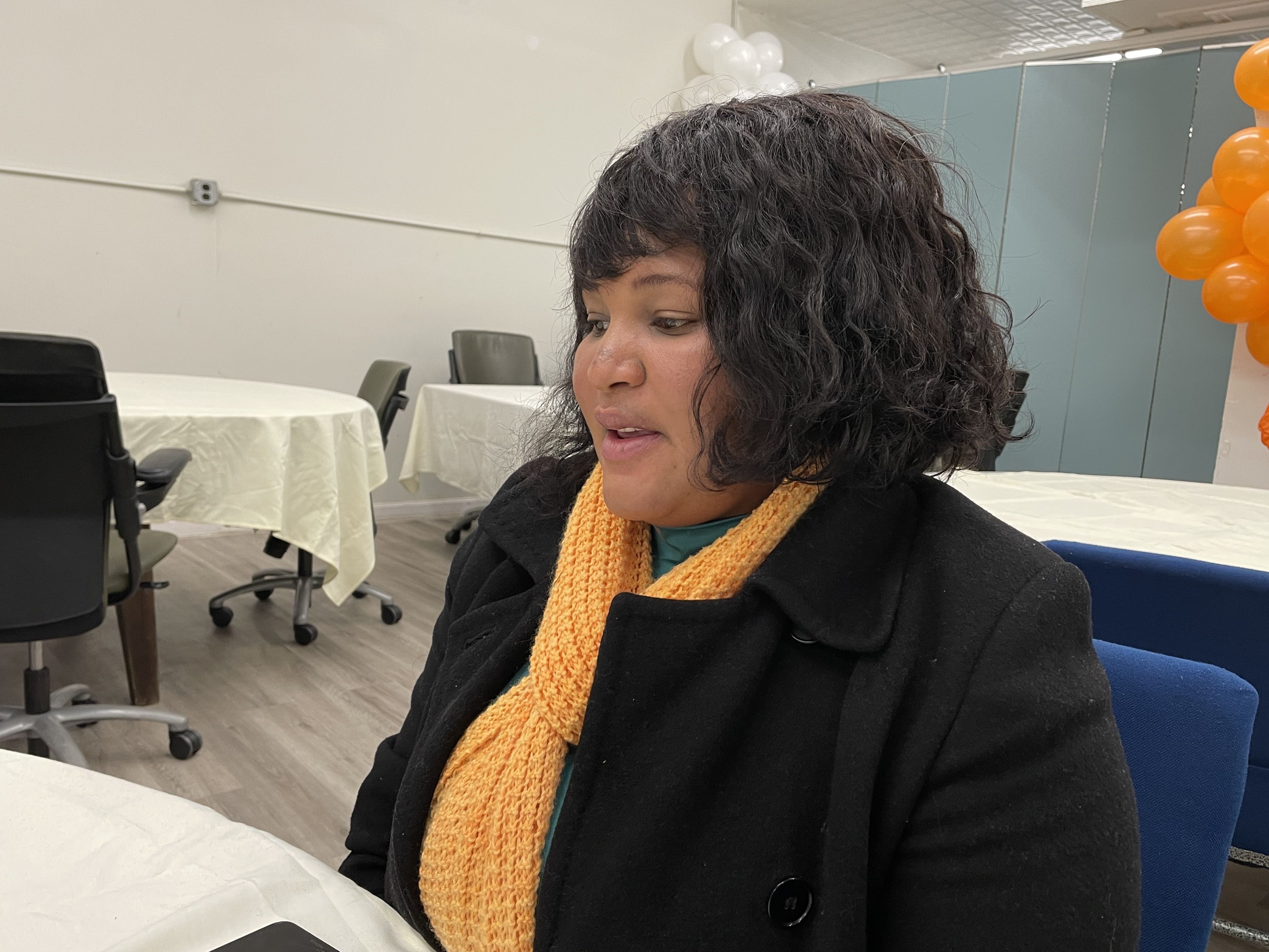 Chancelaine Marlieuse Smith  sits at a table at IFSI-USA in Mattapan for an itnerview.
