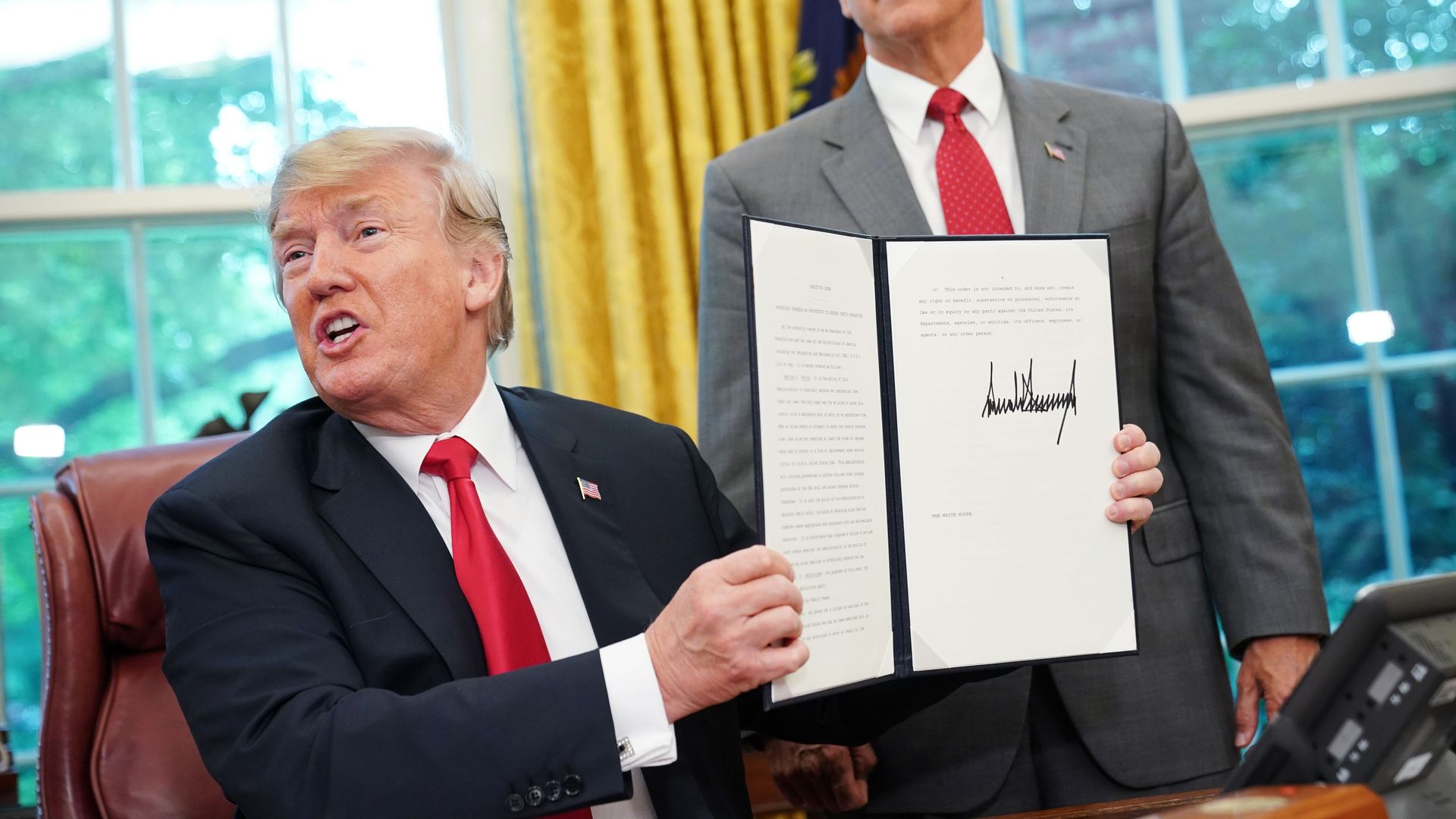 Trump holding up an executive order