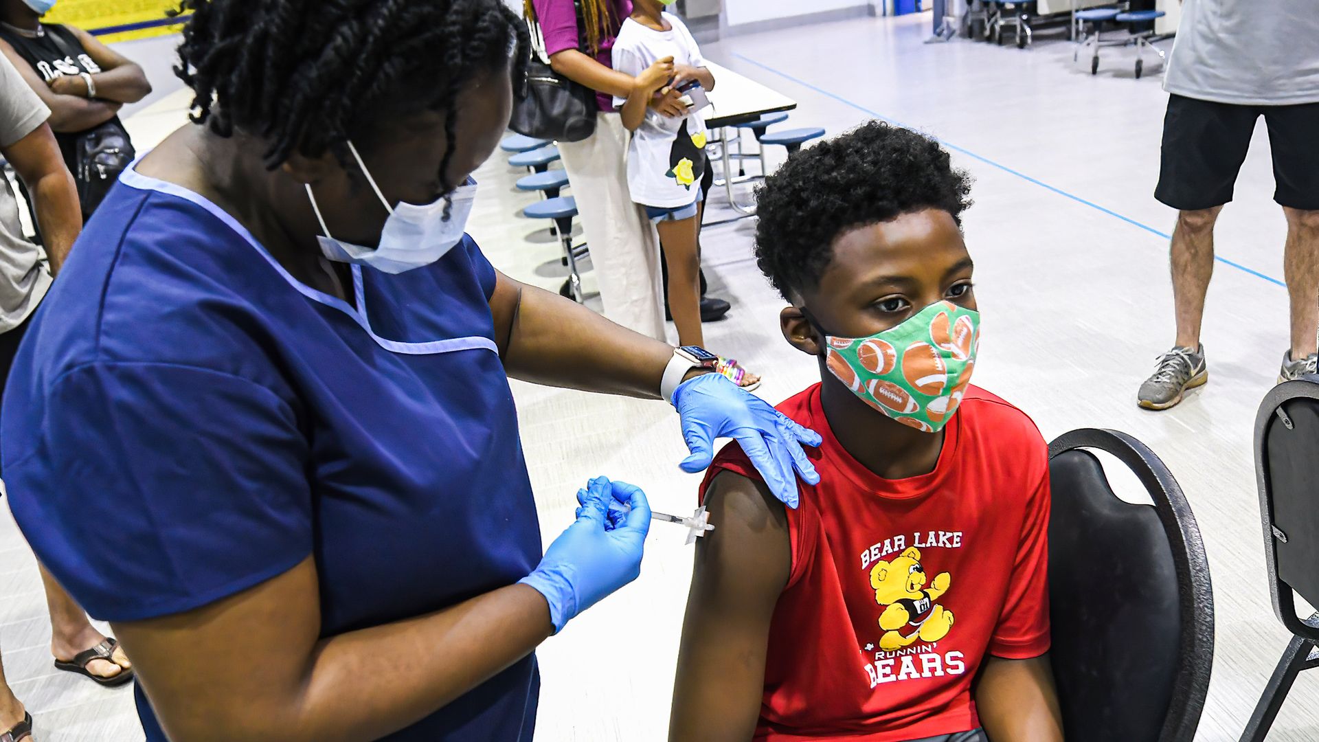 Picture of a nurse giving a boy the vaccine