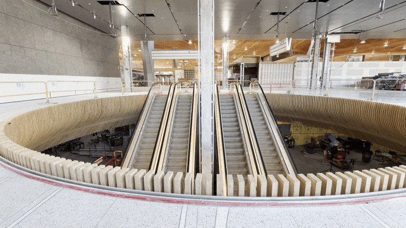 Animate gif shows escalators in a construction zone at PDX.