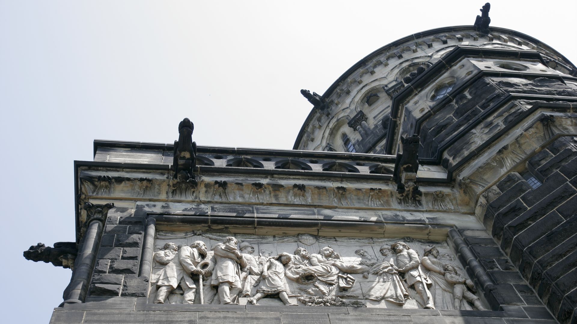 An upshot of a stone monument with a political tableau