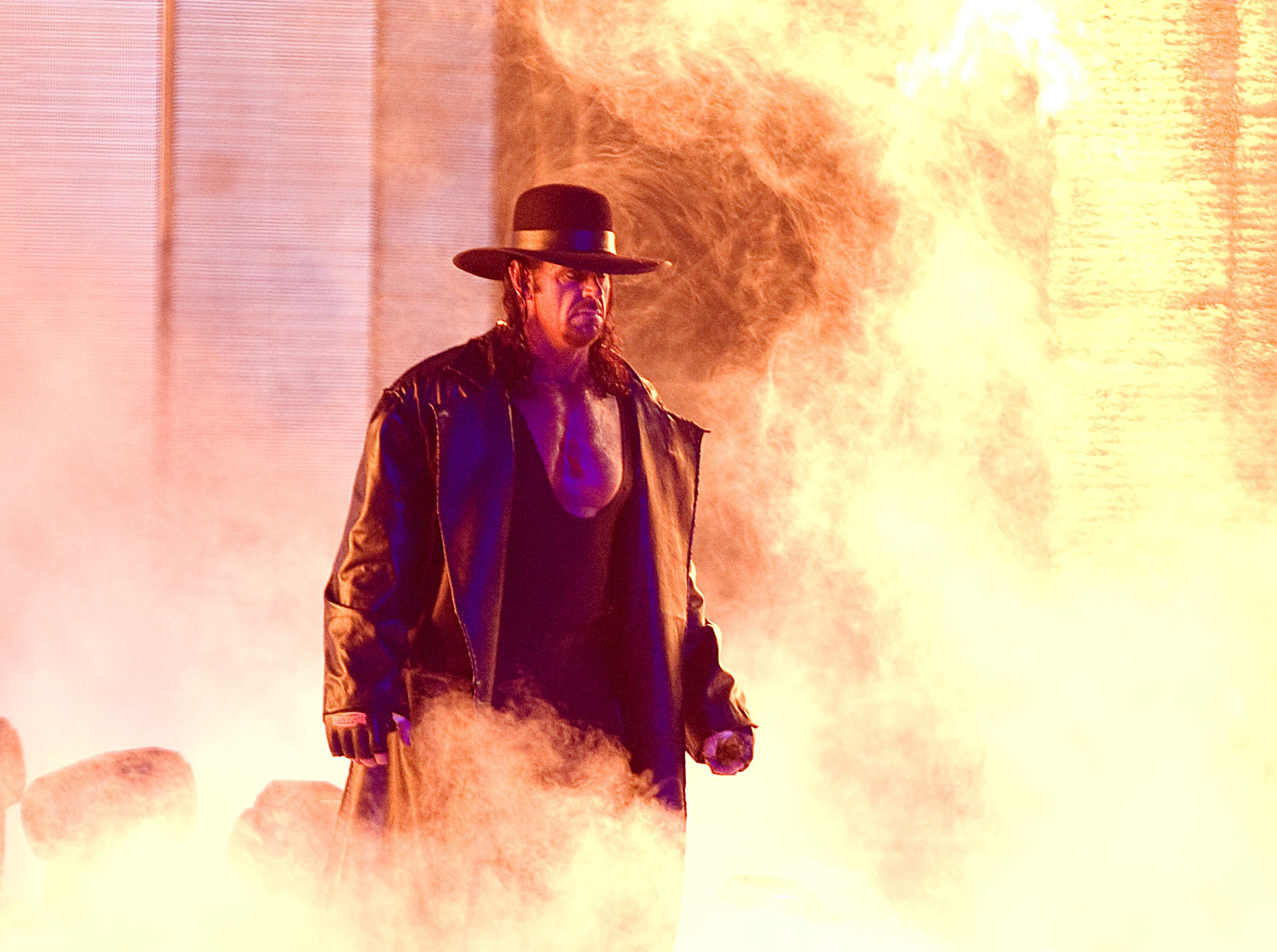 WWE star The Undertaker walks to the ring.