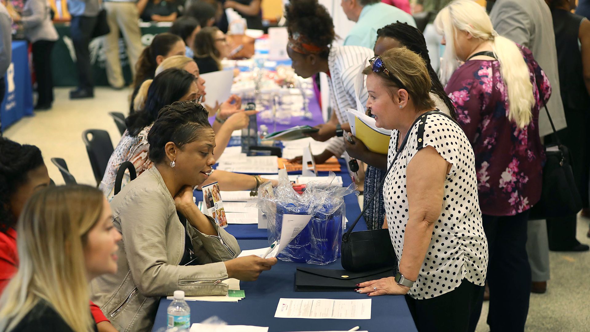People attend a job fair in Miami, Fla., in April 2019.