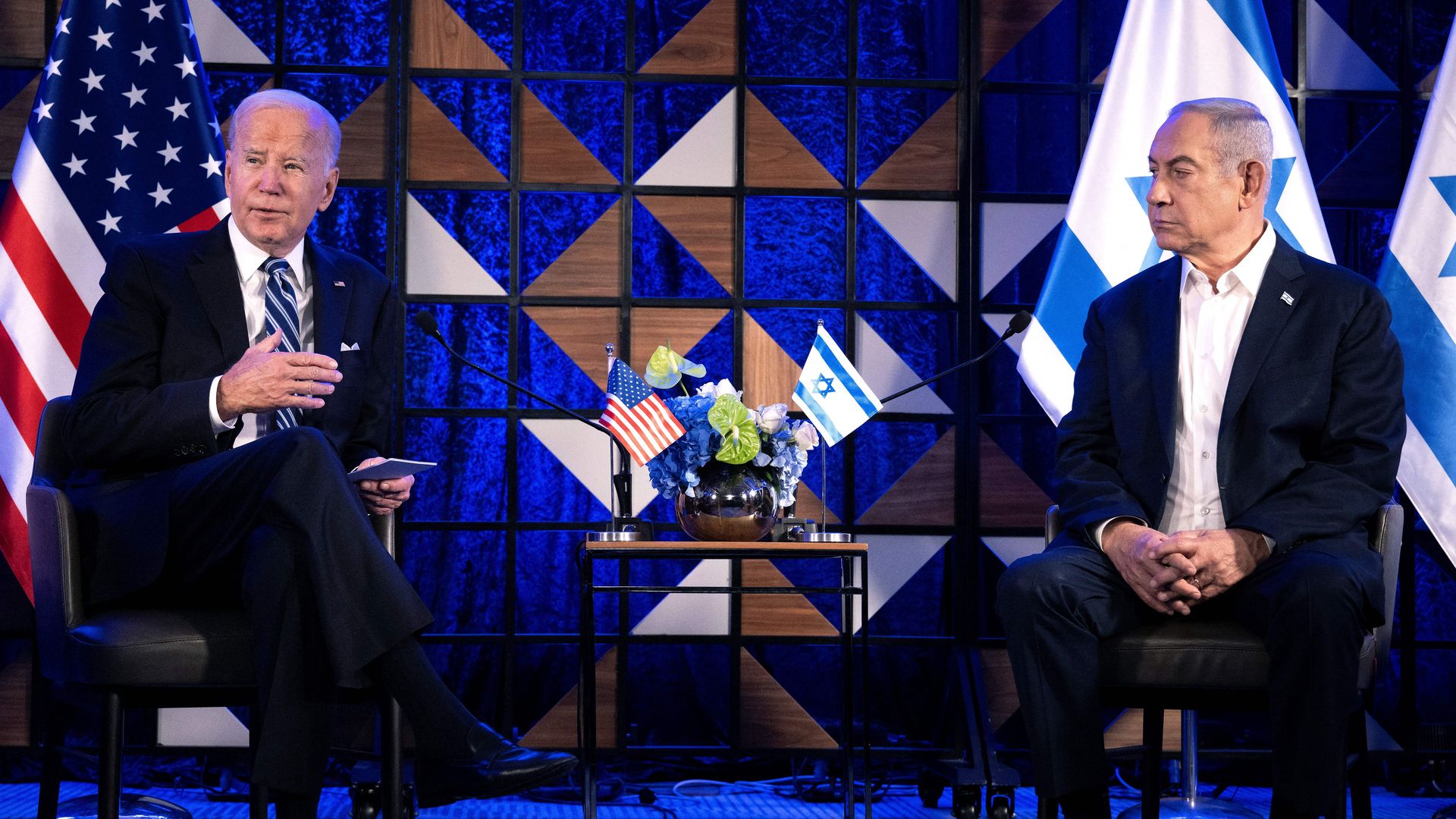 US President Joe Biden (L) speaks as Israel's Prime Minister Benjamin Netanyahu listens on prior to their meeting in Tel Aviv on October 18, 2023, amid the ongoing battles between Israel and the Palestinian group Hamas.