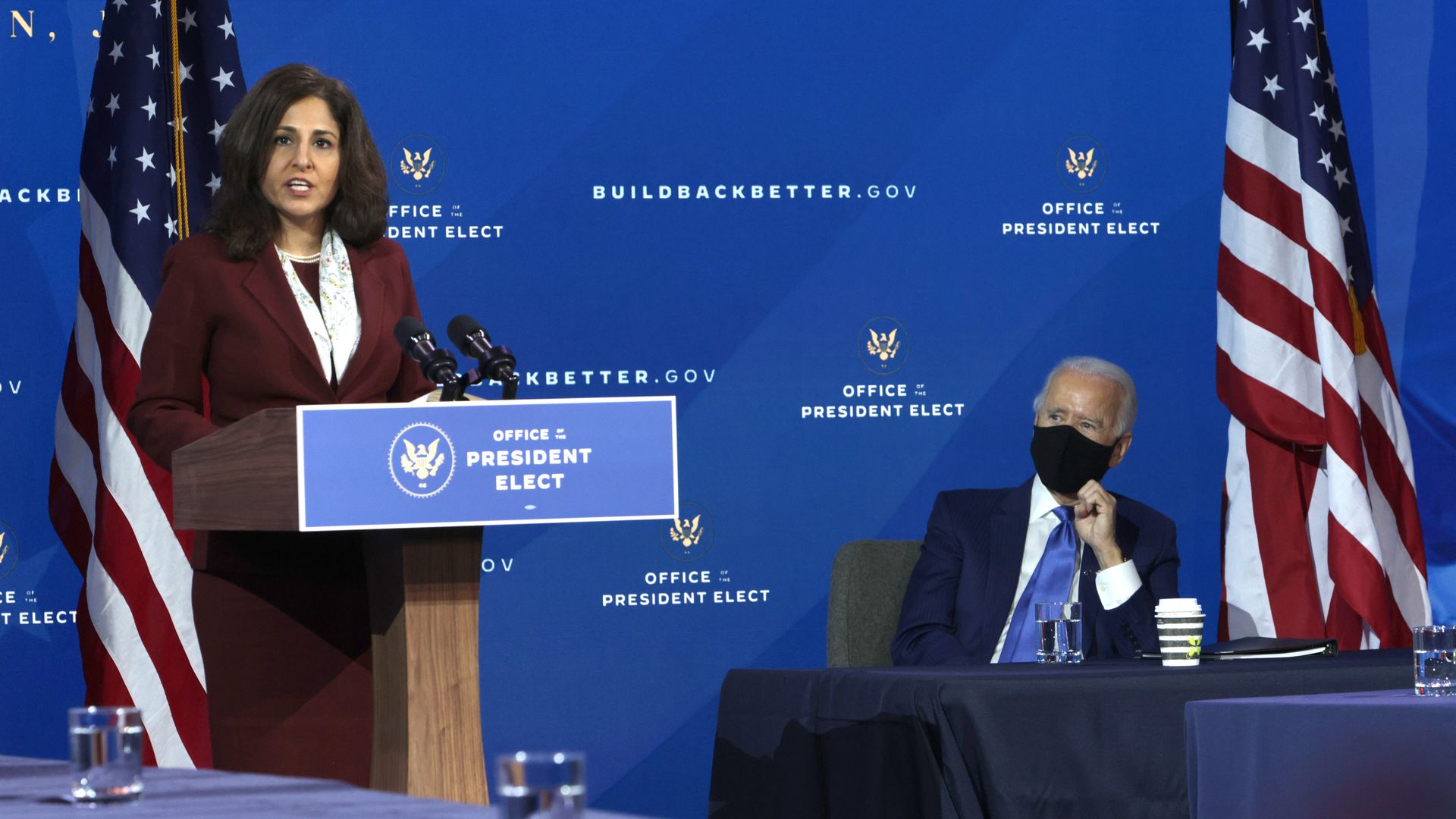 President-elect Joe Biden looks on as Neera Tanden speaks Tuesday following her nomination to be OMB director.
