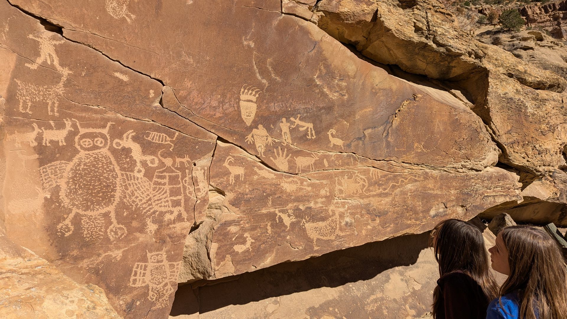 Kids admire a panel of rock art at Nine Mile Canyon in Carbon County.