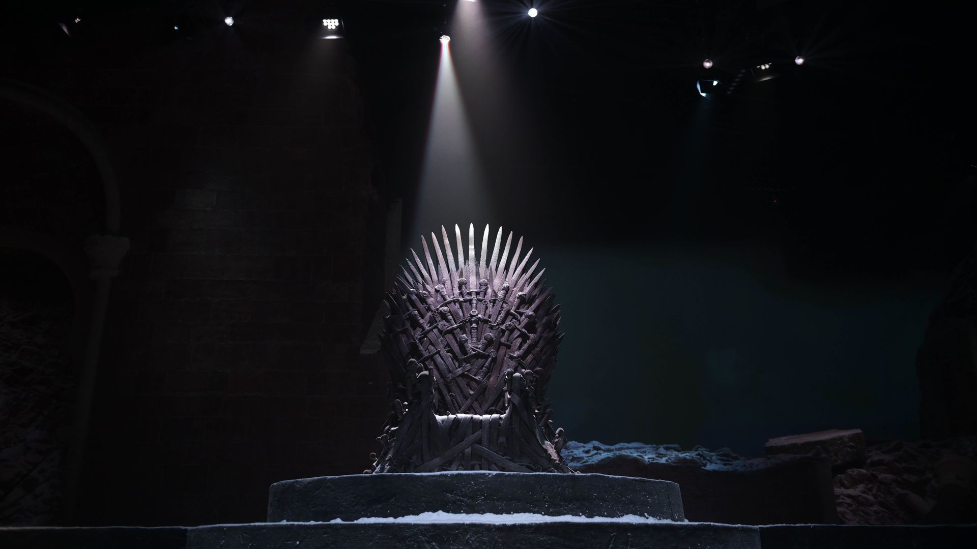 Photo of the Iron Throne spotlighted in the middle of a studio