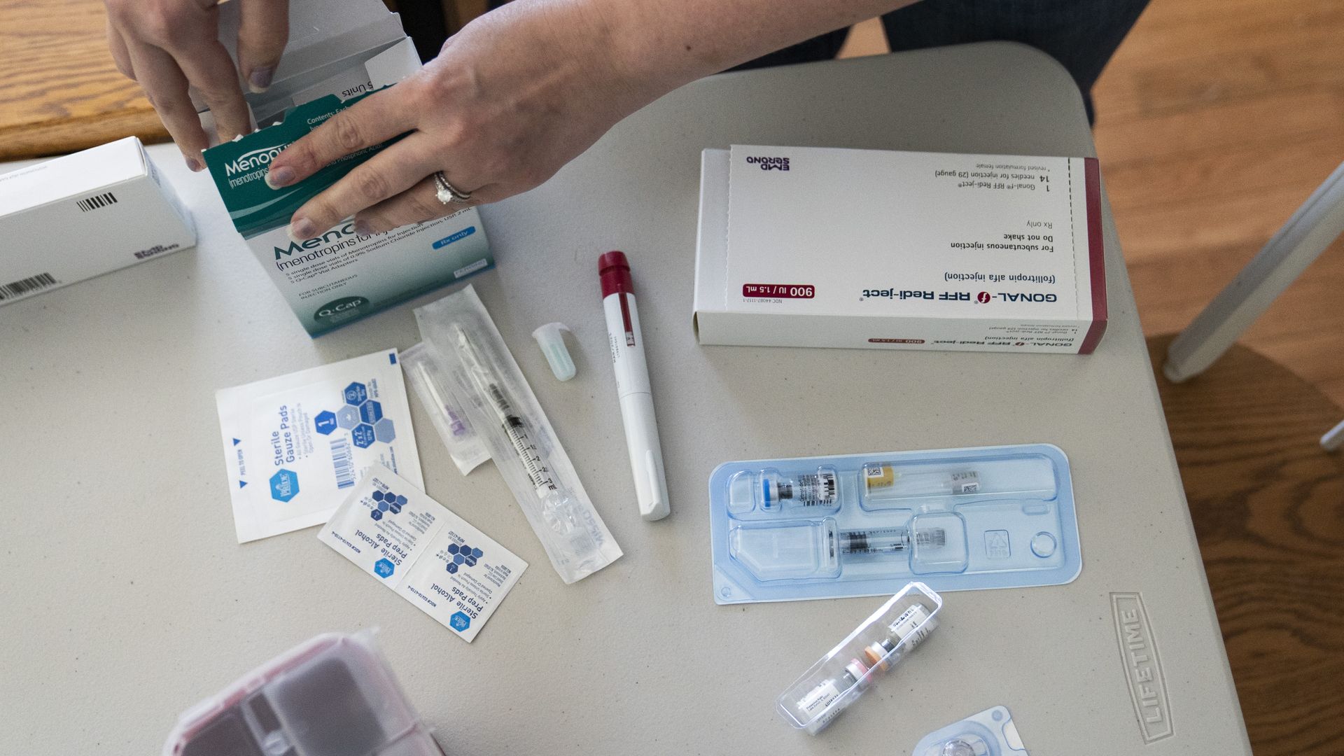 Nina Osborne, who has done several rounds of IVF in hopes of fulfilling her lifelong dream of having children, goes through her IVF medications at home in Parkville, MD on May 10, 2022.