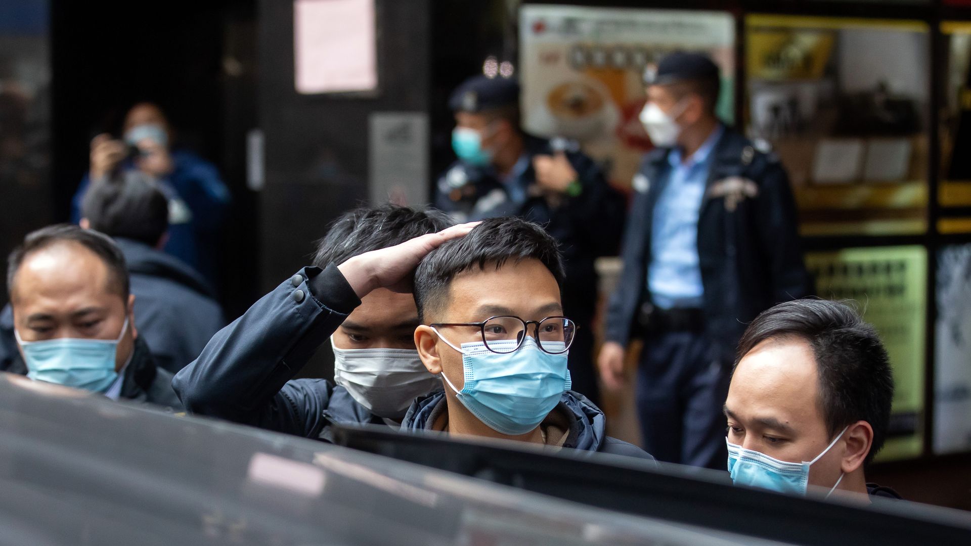  Stand News' Patrick Lam is escorted by officers with the Hong Kong Policeduring a raid of the media outlet's offices in Hong Kong, China, on Wednesday, Dec. 29. 