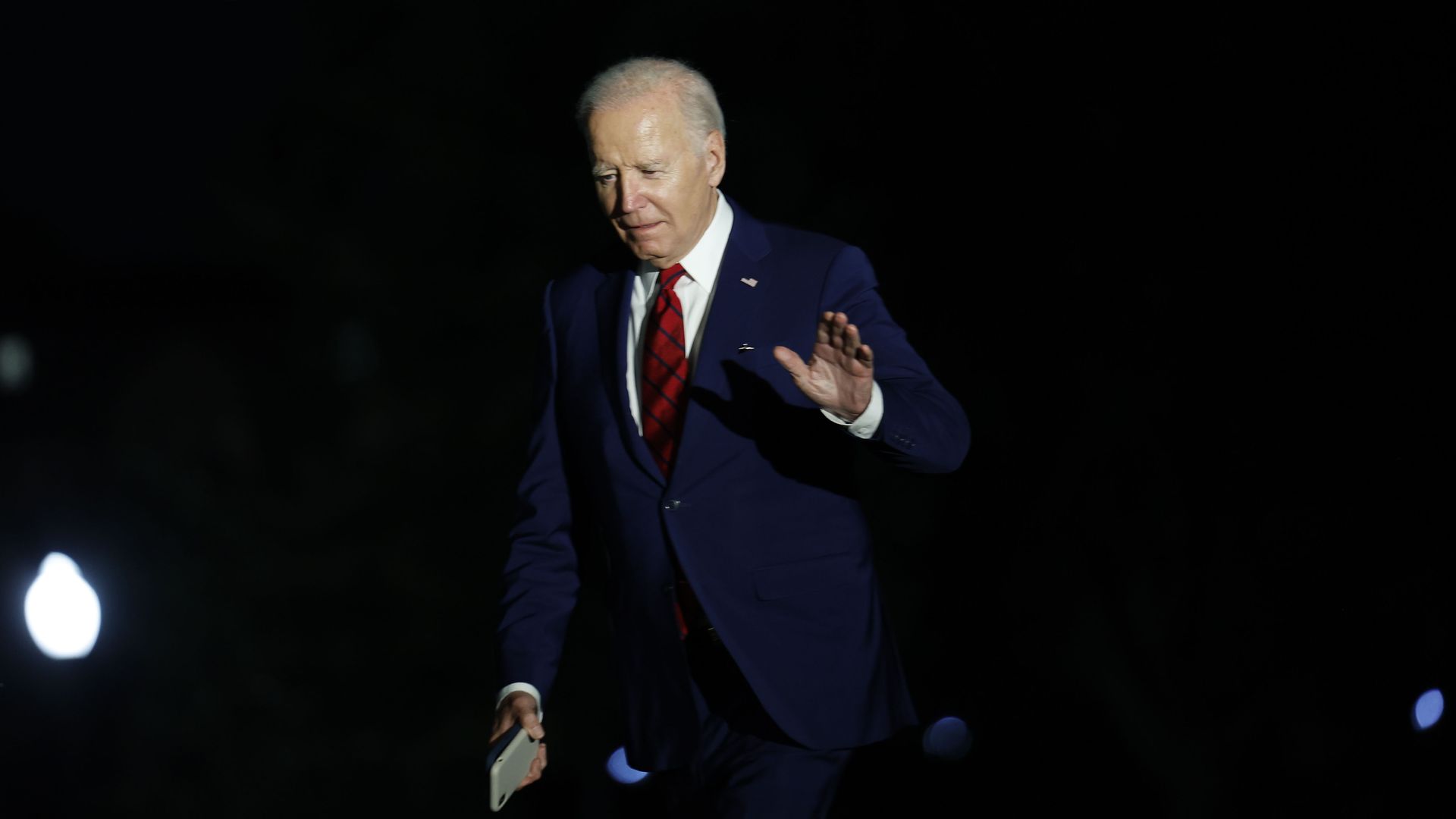Joe Biden walks alone toward the White House.