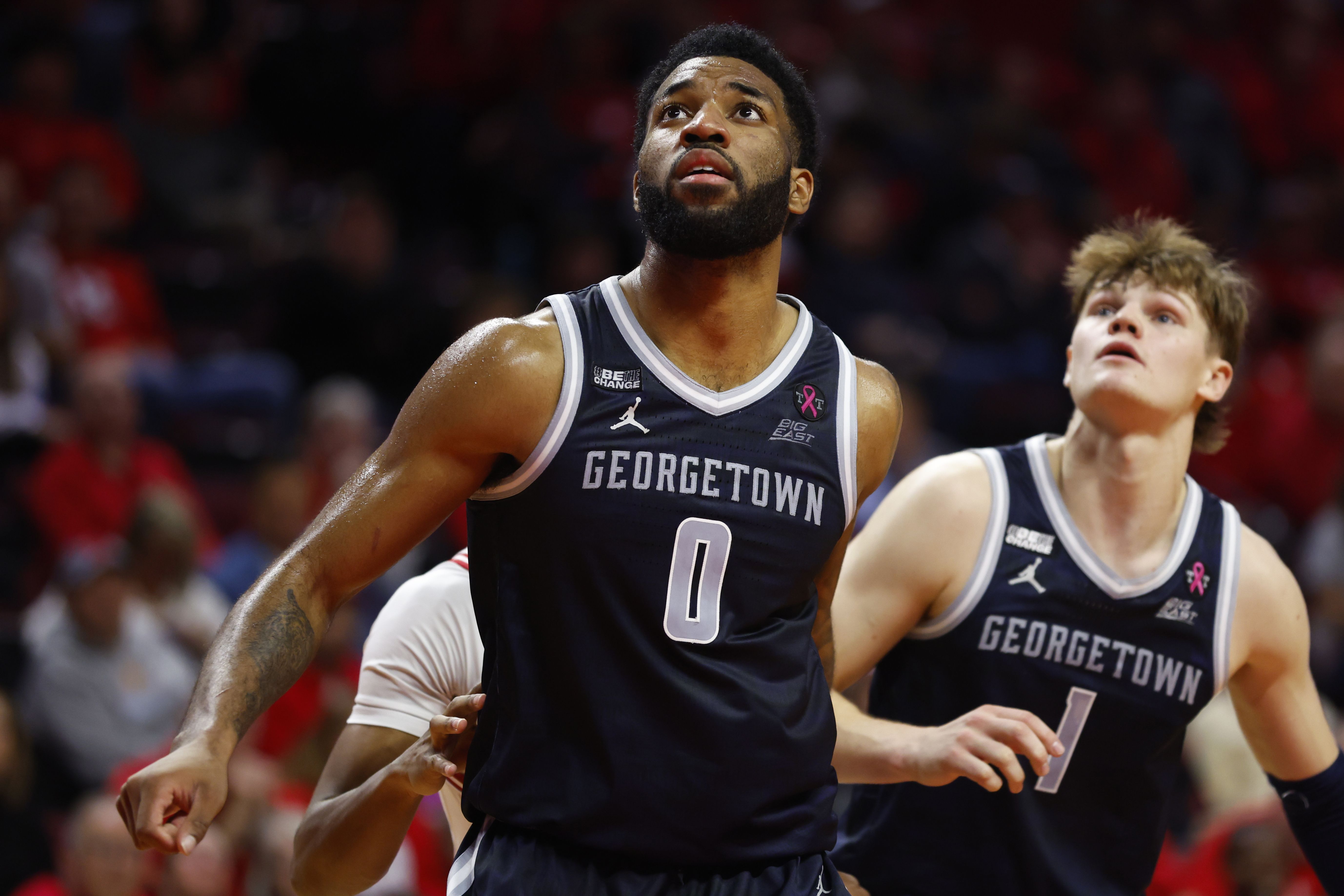 Photo of basketball players going for a rebound in a basketball game 
